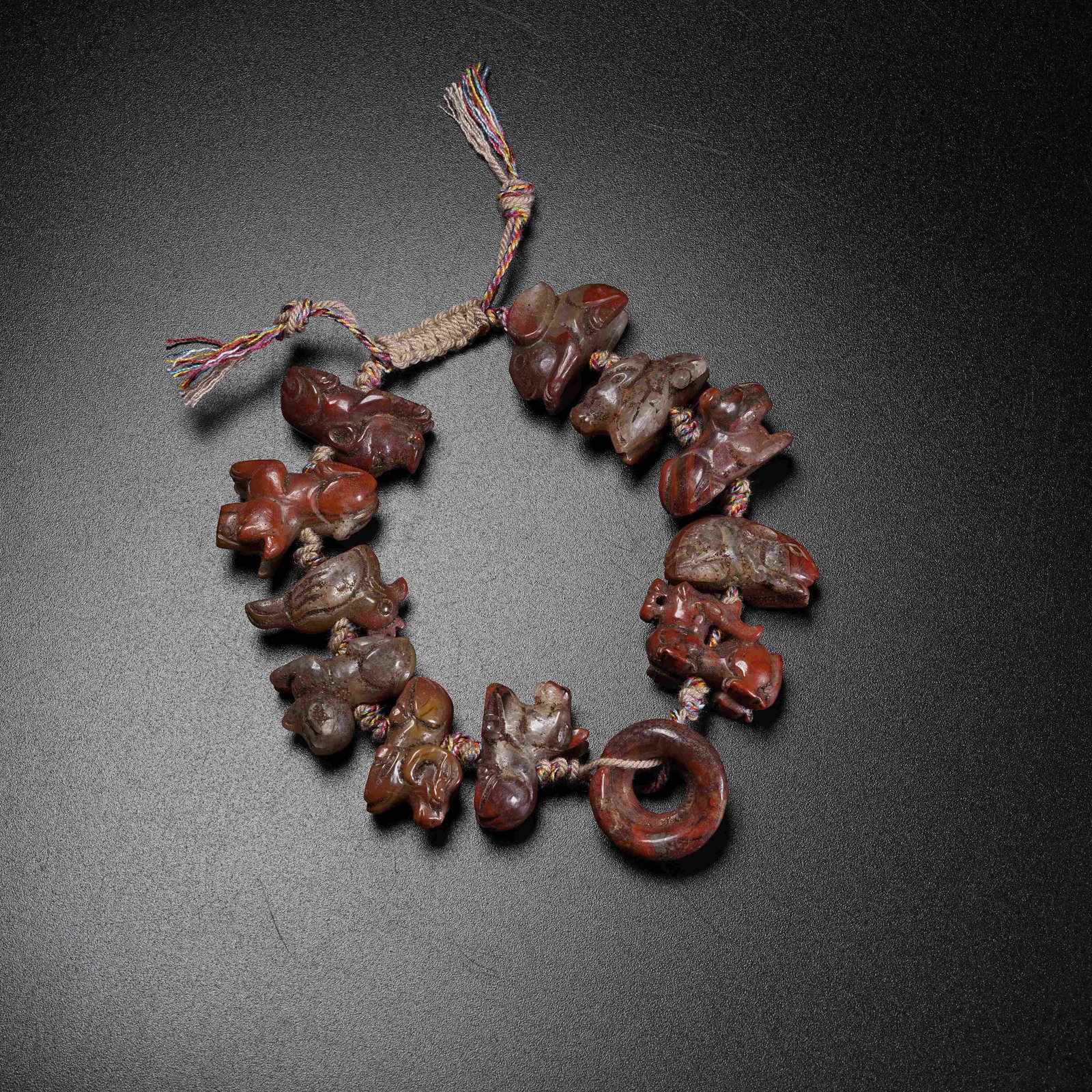 A WARRING STATES RED AGATE BRACELET WITH TWELVE CHINESE ZODIAC ANIMALS: Warring States Red Agate Bracelet with Twelve Chinese Zodiac Animals