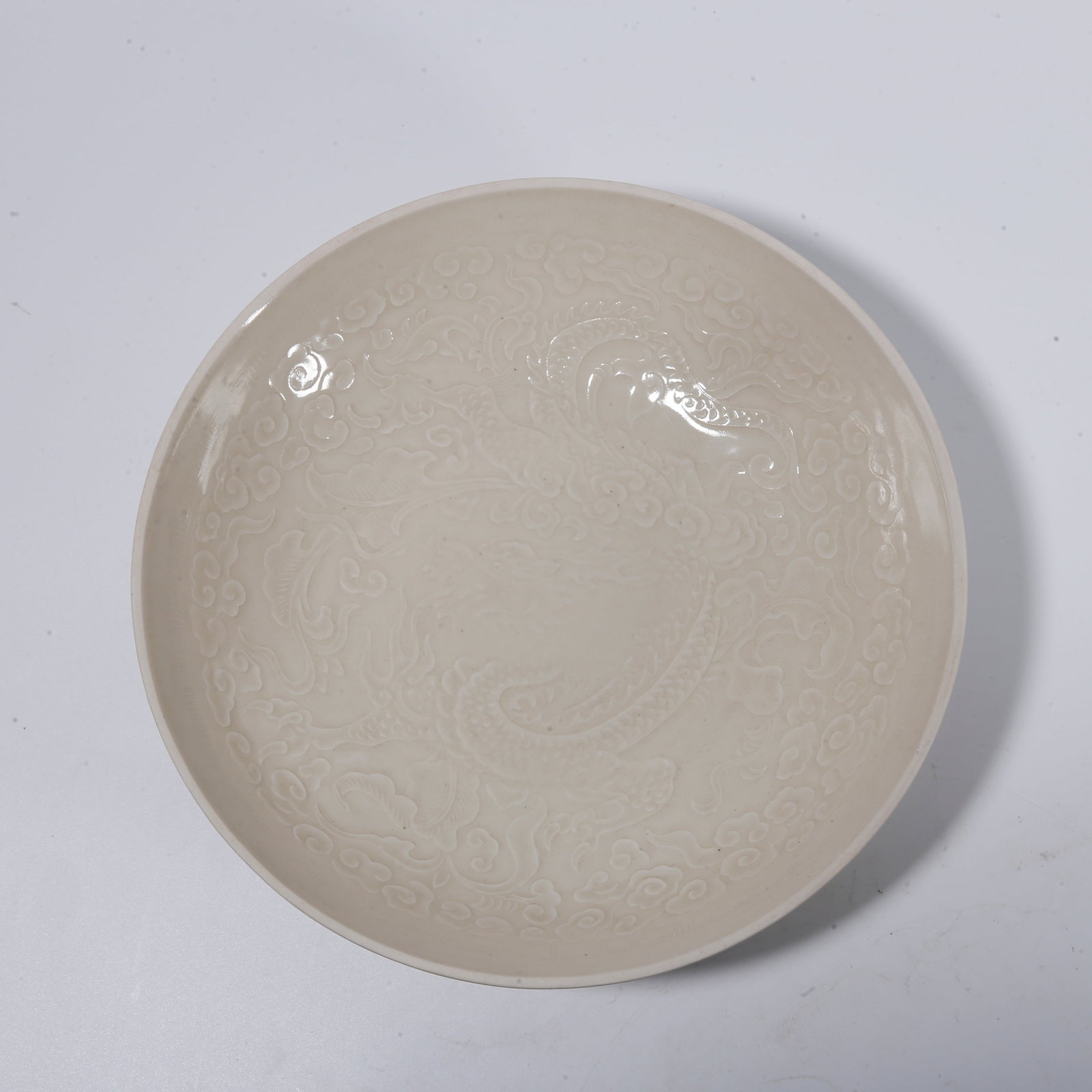 A DING-KILN WASHER WITH CLOUD-DRAGON PATTERN (1 of 8)