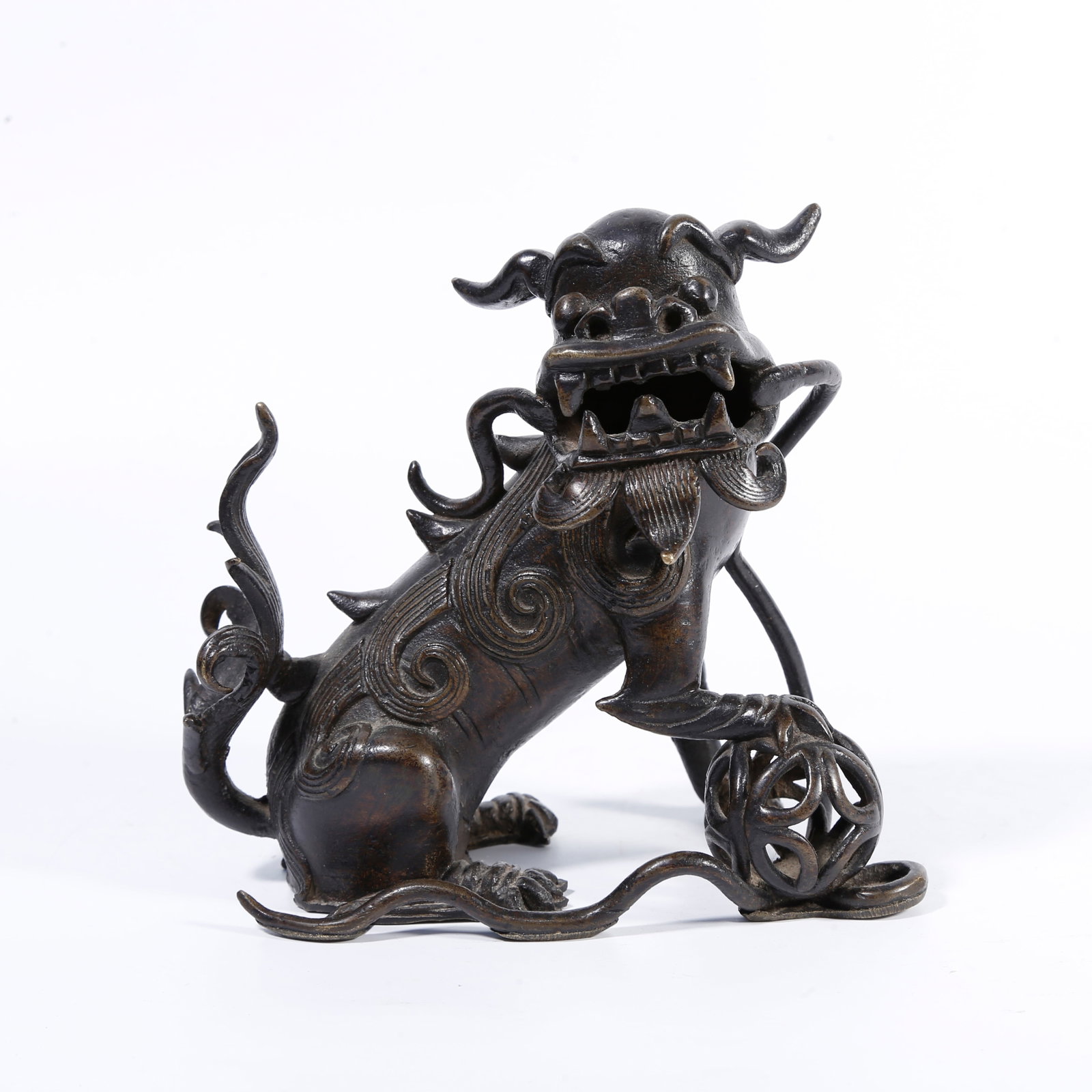 A BRONZE LION-PLAYING-WITH-EMBROIDERED-BALL ORNAMENT: Bronze lion-playing-with-embroidered-ball ornament