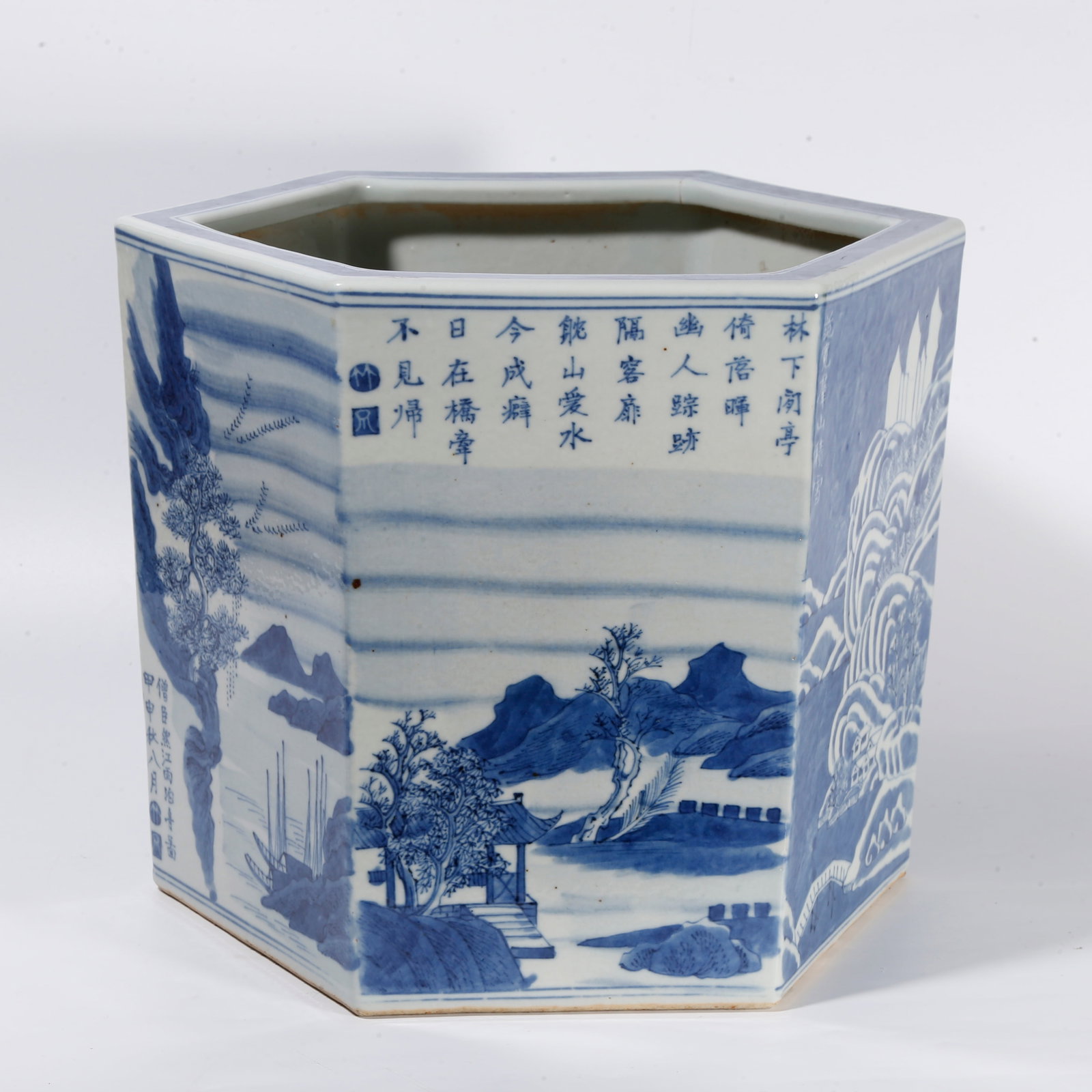 A BLUE AND WHITE HEXAGONAL SCROLL POT WITH LANDSCAPE PATTERN: Blue and white hexagonal scroll pot with landscape pattern