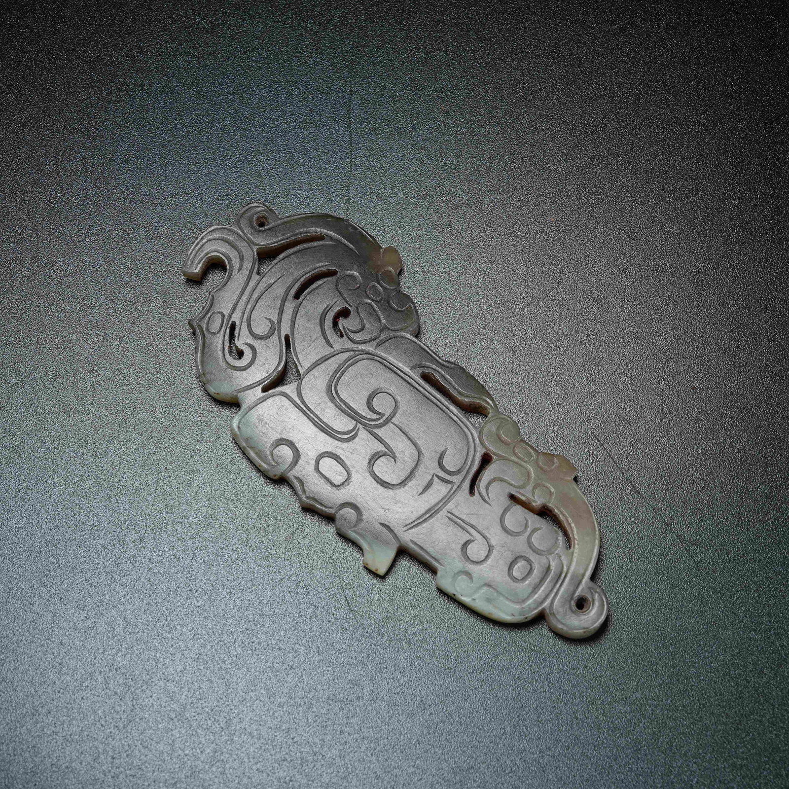 A ANCIENT JADE PENDANT WITH DIVINE MASK MOTIF: Ancient Jade Pendant with Divine Mask Motif