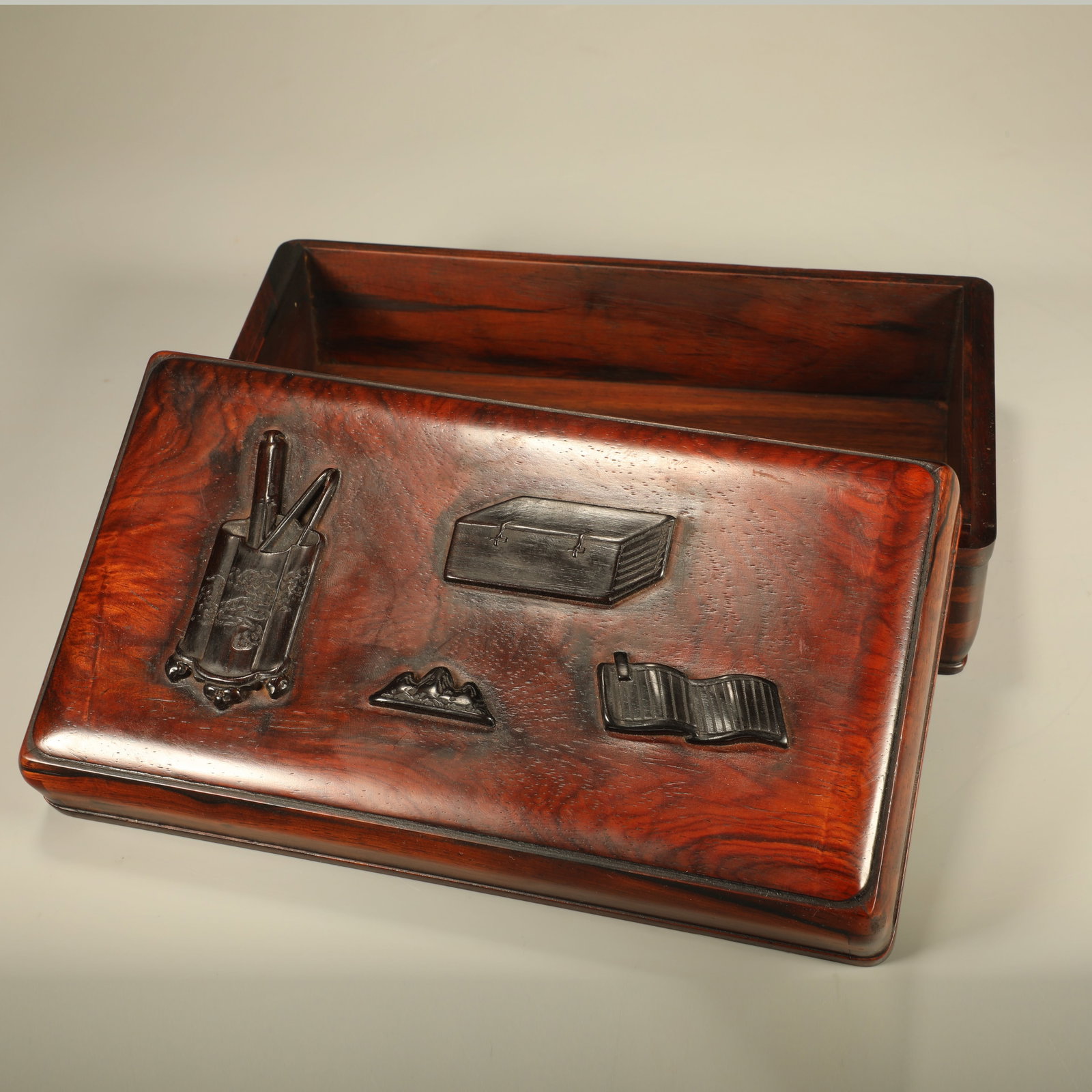 A HUANGHUALI BOX INLAID WITH SANDALWOOD CARVED WITH ANTIQUE-OBJECT MOTIFS: Huanghuali Box Inlaid with Sandalwood Carved with Antique-object Motifs