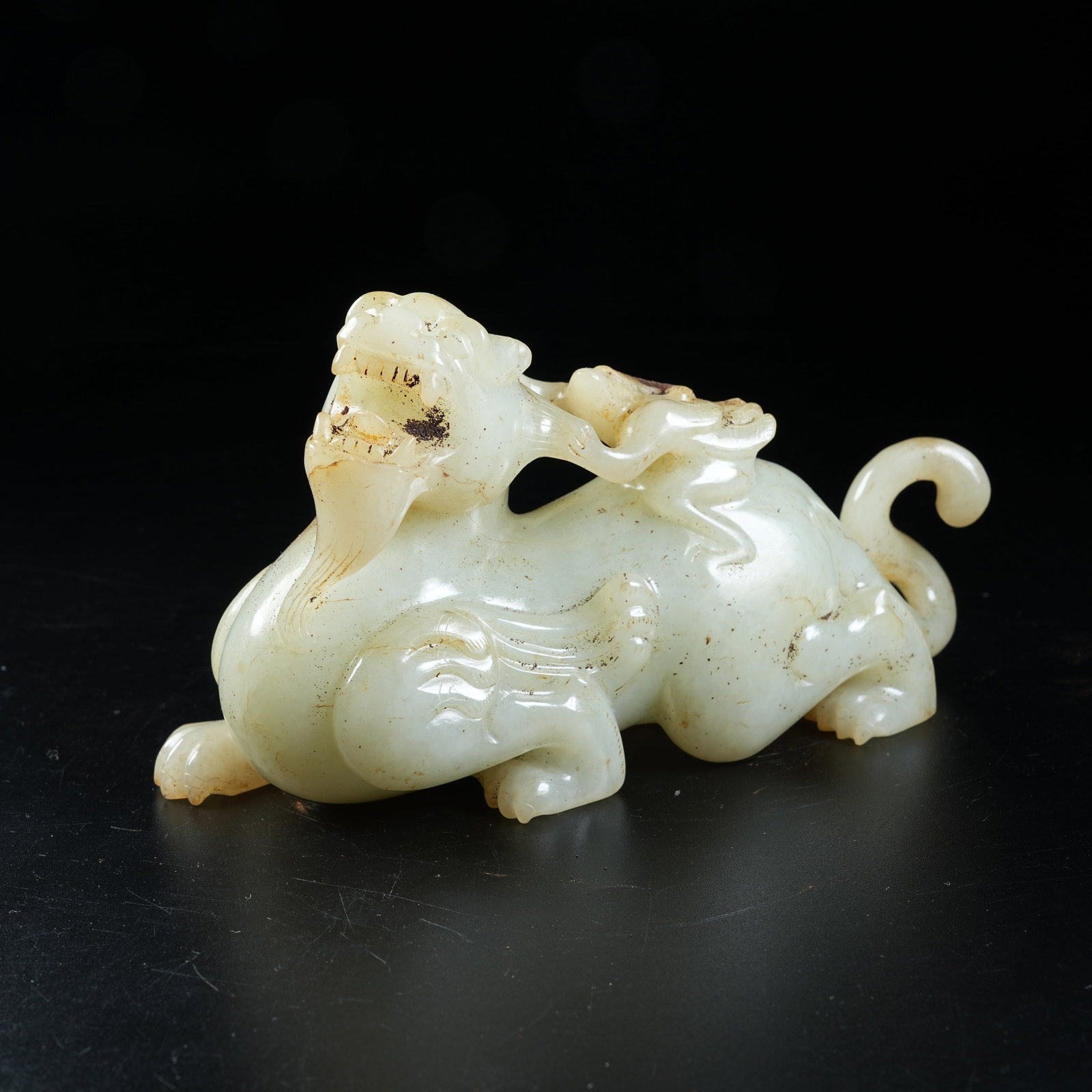 A ANCIENT JADE WINGED FIGURE RIDING BEAST ORNAMENT: Ancient Jade Winged Figure Riding Beast Ornament