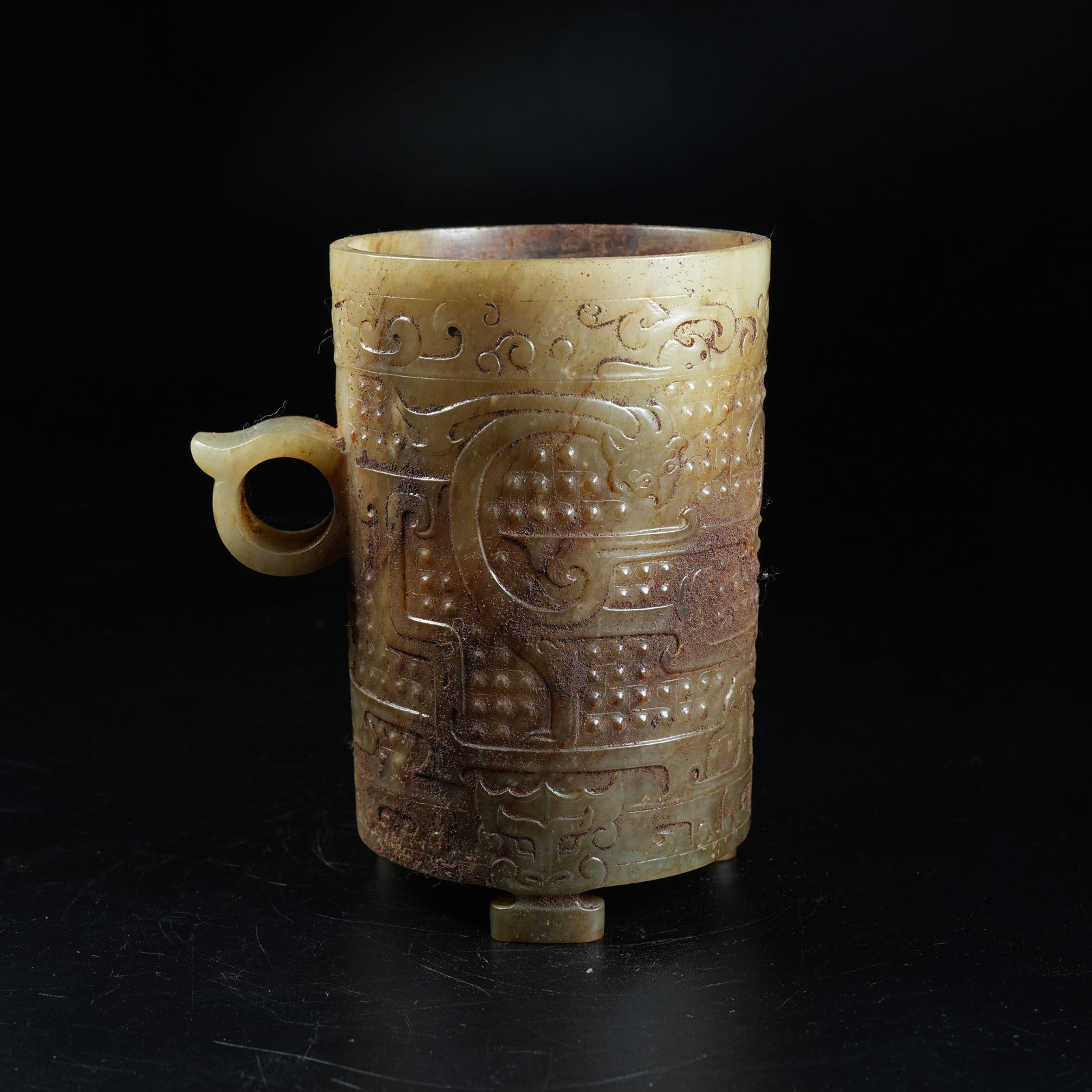 A ANCIENT JADE SLANTED CUP WITH DRAGON PATTERN: Ancient Jade Slanted Cup with Dragon Pattern