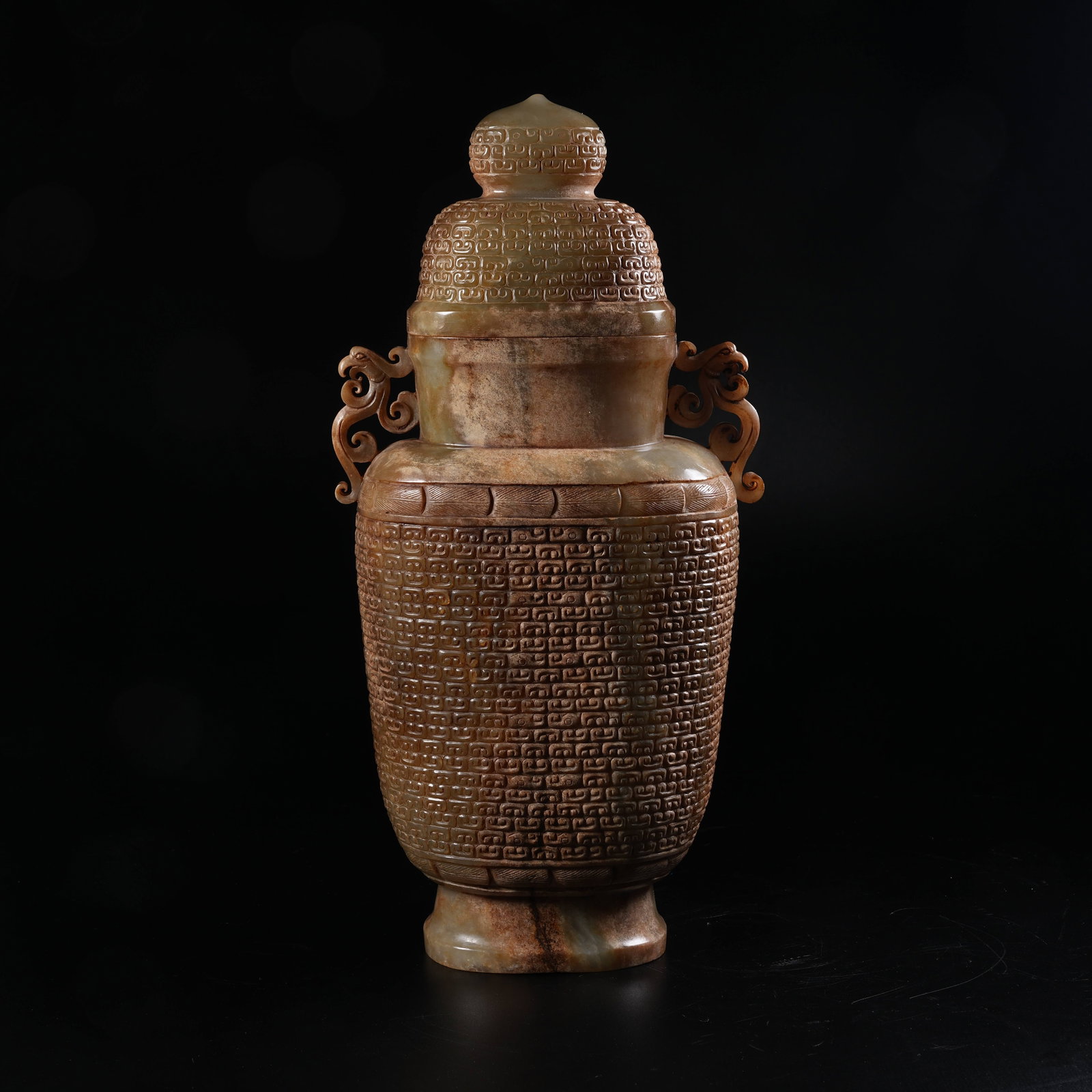 A ANCIENT JADE COVERED VESSEL WITH HOOKED CLOUD PATTERNS AND PHOENIX EARS: Ancient Jade Covered Vessel with Hooked Cloud Patterns and Phoenix Ears