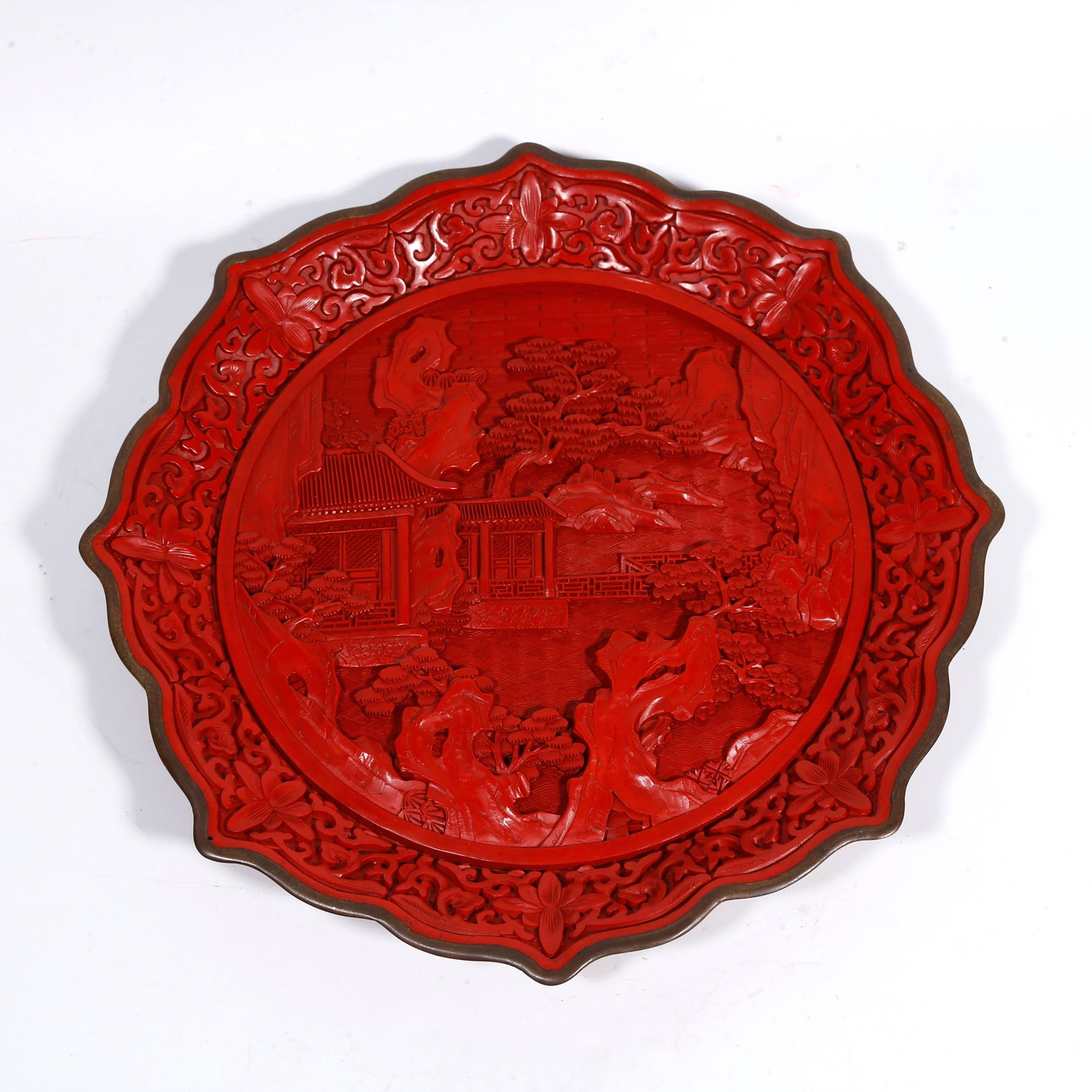 A CARVED-RED PLATE WITH LANDSCAPE PATTERN: Carved-red plate with landscape pattern