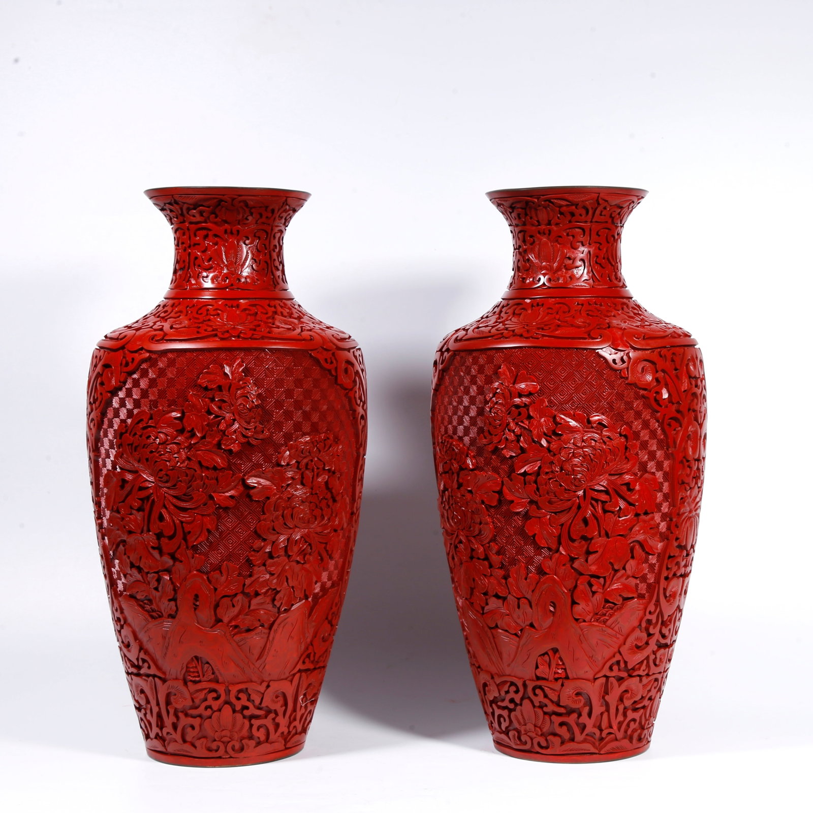 A BRONZE-BODY CARVED-RED VASE WITH ROCK-AND-FLOWER PATTERN (PAIR): Bronze-body carved-red vase with rock-and-flower pattern (pair)