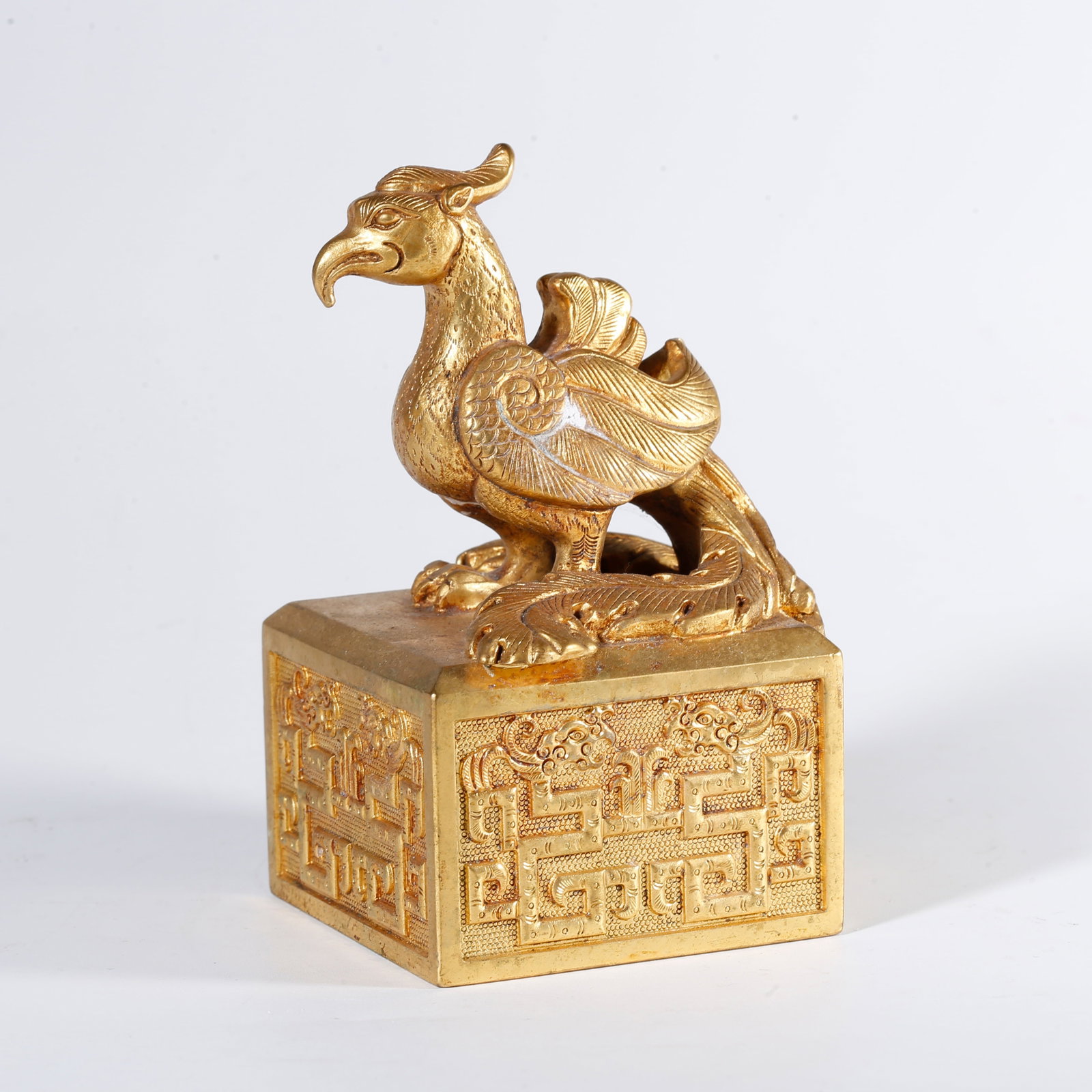 A GILT BRONZE SEAL WITH PHOENIX KNOB: Gilt Bronze Seal with Phoenix Knob