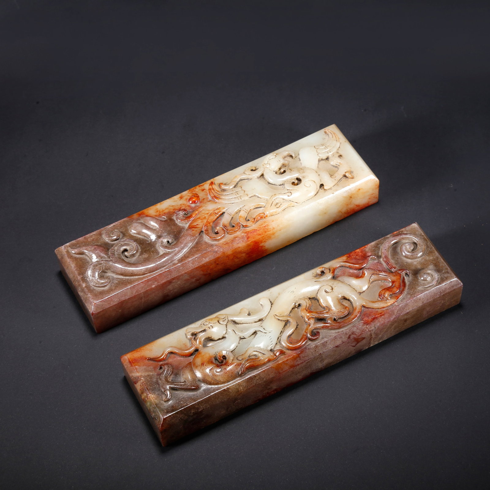 A PAIR OF HETIAN JADE PAPER WEIGHTS CARVED WITH DRAGON AND PHOENIX PATTERN: Pair of Hetian Jade Paper Weights Carved with Dragon and Phoenix Pattern