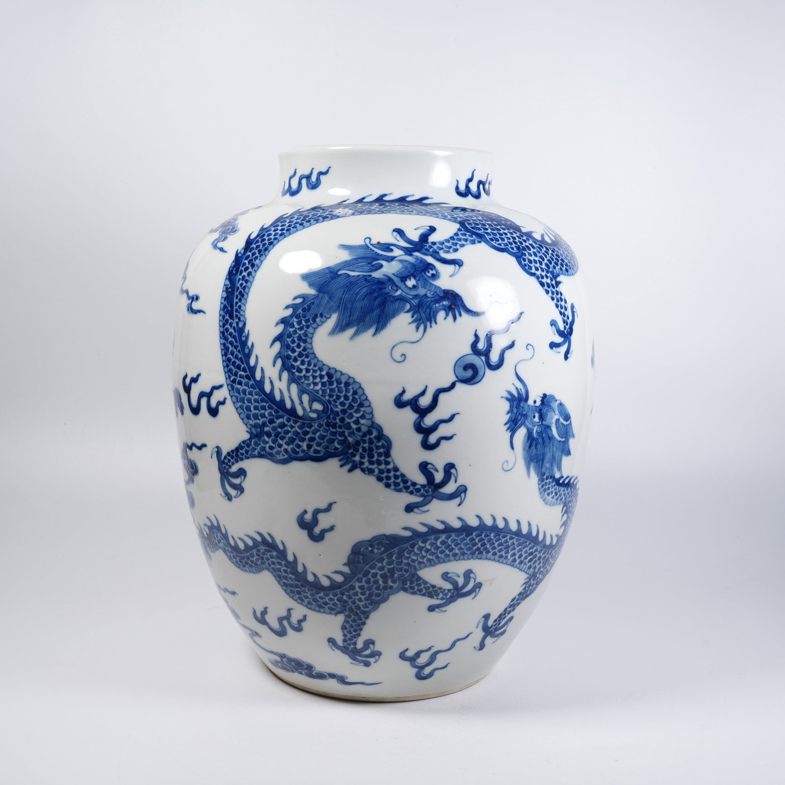 A BLUE AND WHITE JAR WITH CLOUD DRAGON CHASING PEARL PATTERNS: Blue and White Jar with Cloud Dragon Chasing Pearl Patterns