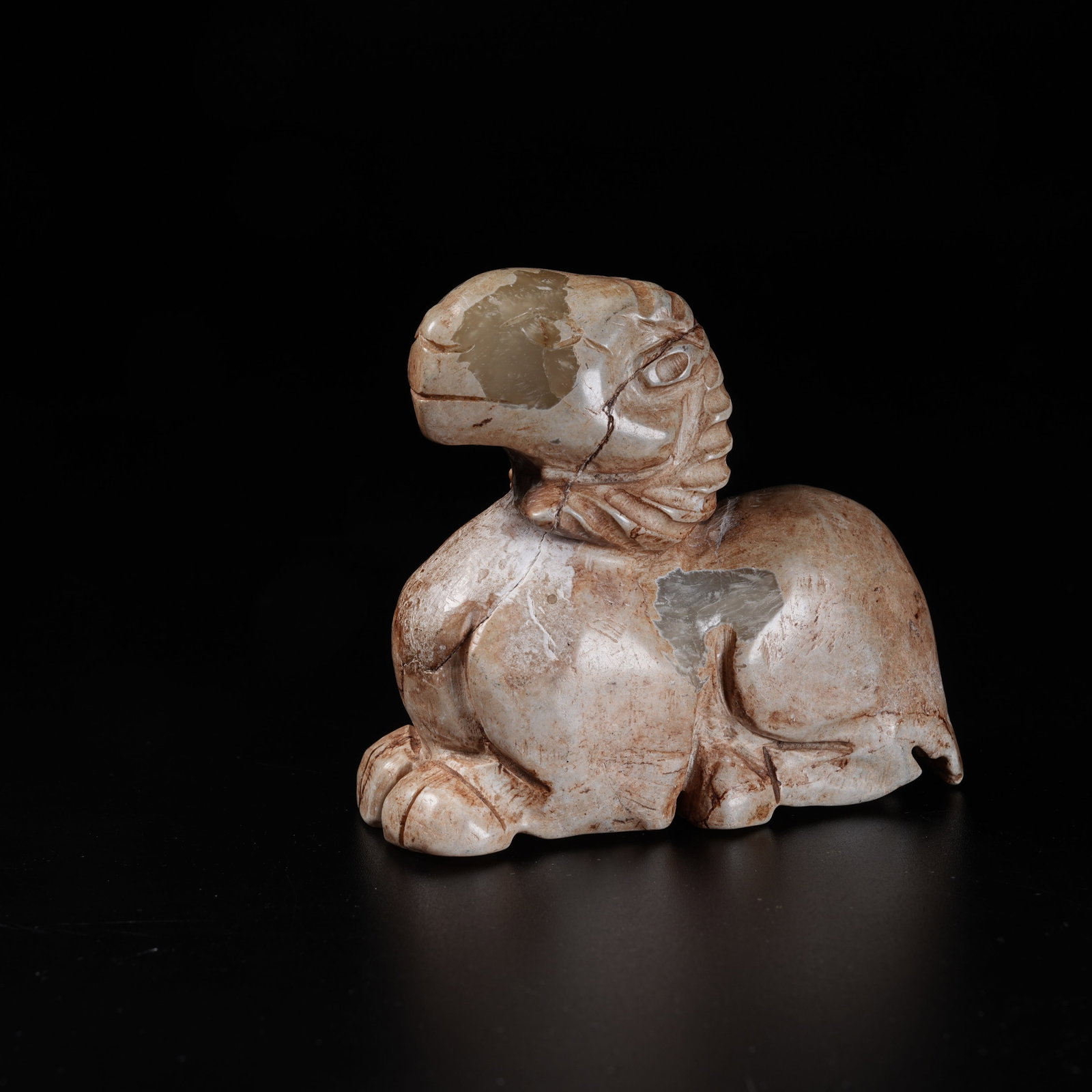 A ARCHAIC JADE RECUMBENT SHEEP ORNAMENT: Archaic Jade Recumbent Sheep Ornament
