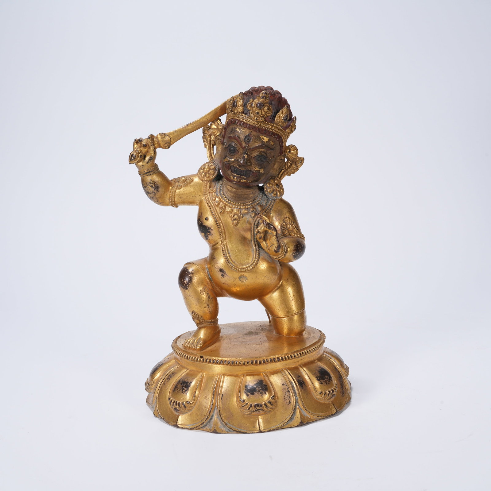 A GILT-BRONZE DHARMA-PROTECTOR FIGURE: Gilt-bronze dharma-protector figure