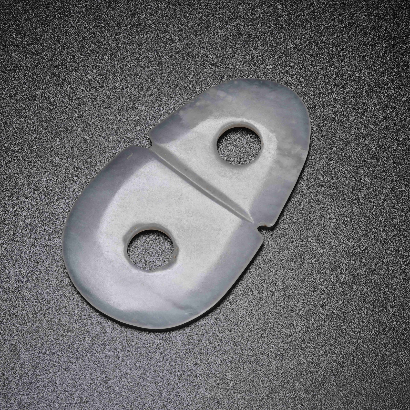 A ARCHAIC JADE FIGURE-EIGHT RING PENDANT: Archaic Jade Figure-eight Ring Pendant