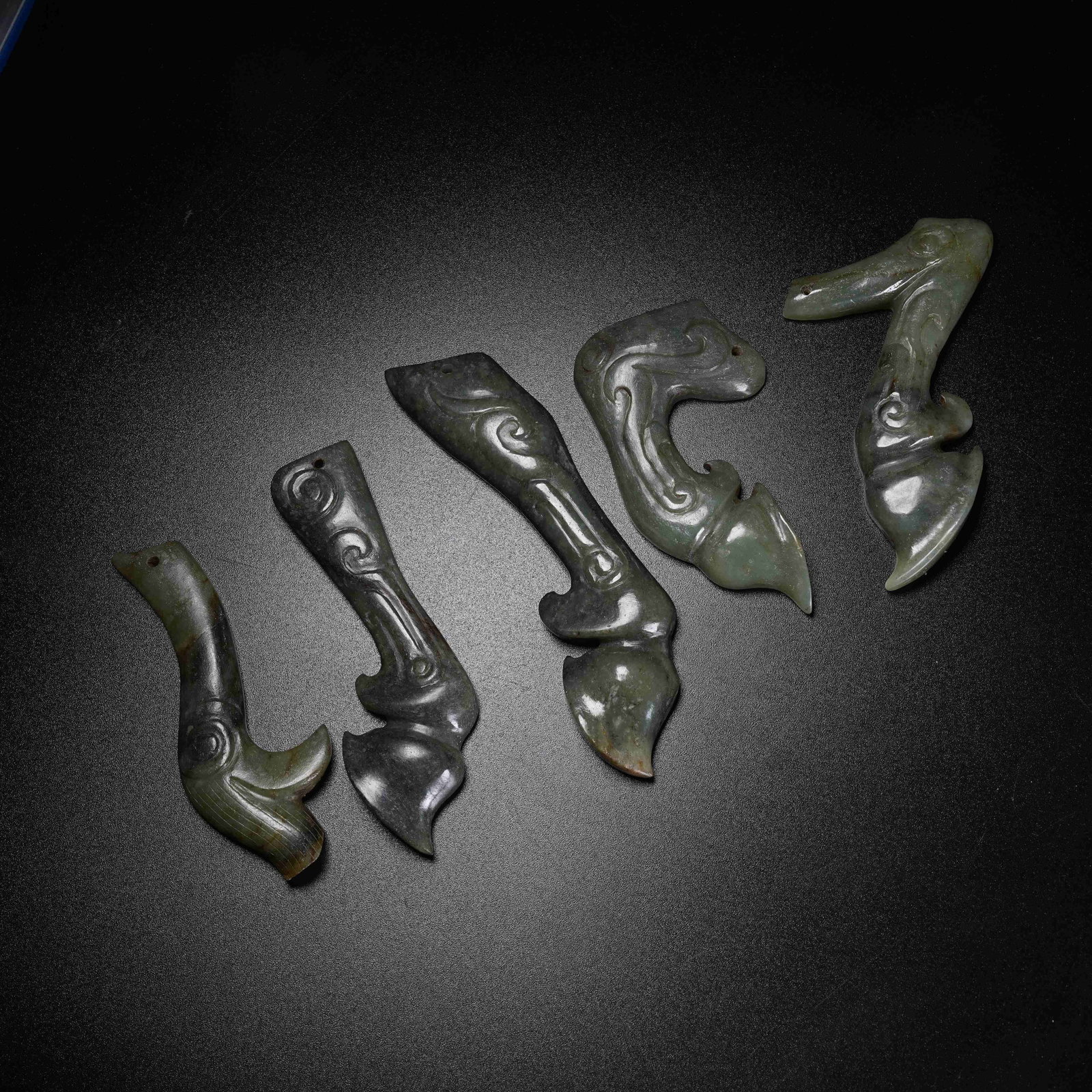A SET OF ARCHAIC JADE OX HOOF PENDANTS: Set of Archaic Jade Ox Hoof Pendants