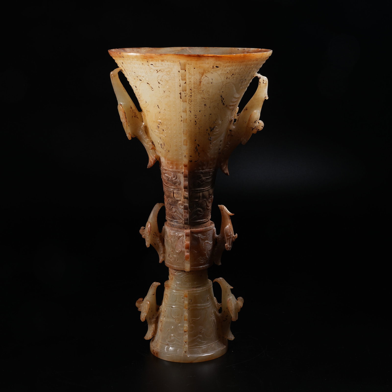 A ANCIENT JADE FLANGED GU WINE VESSEL WITH BEAST MASK AND DIVINE PHOENIX PATTERNS (1 of 10)