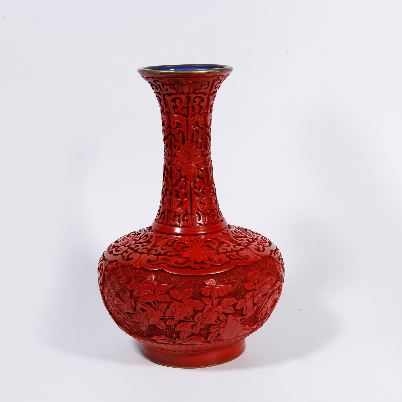 A BRONZE-BODY CARVED-RED PLATE-MOUTH VASE WITH ROCK-AND-FLOWER PATTERN: Bronze-body carved-red plate-mouth vase with rock-and-flower pattern