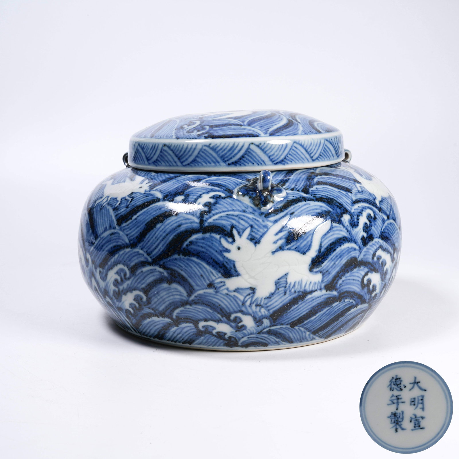A BLUE AND WHITE THREE-HANDLED COVERED JAR WITH RESERVED WHITE MARINE BEAST PATTERNS: Blue and White Three-Handled Covered Jar with Reserved White Marine Beast Patterns