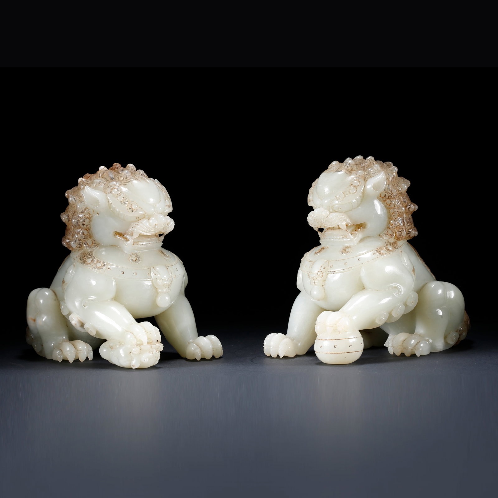 A PAIR OF HETIAN JADE LION ORNAMENTS: Pair of Hetian Jade Lion Ornaments