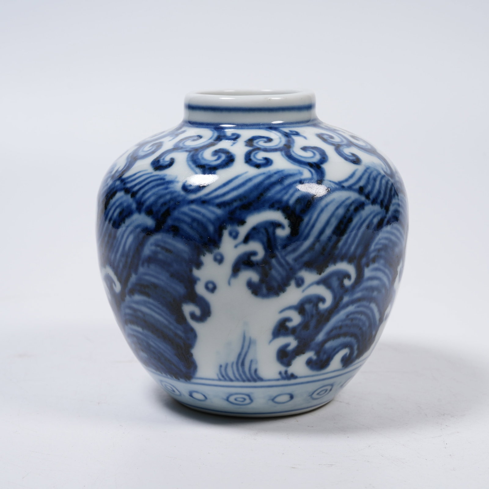 A BLUE AND WHITE JAR WITH RESERVED WHITE SEA WAVE PATTERNS (1 of 9)