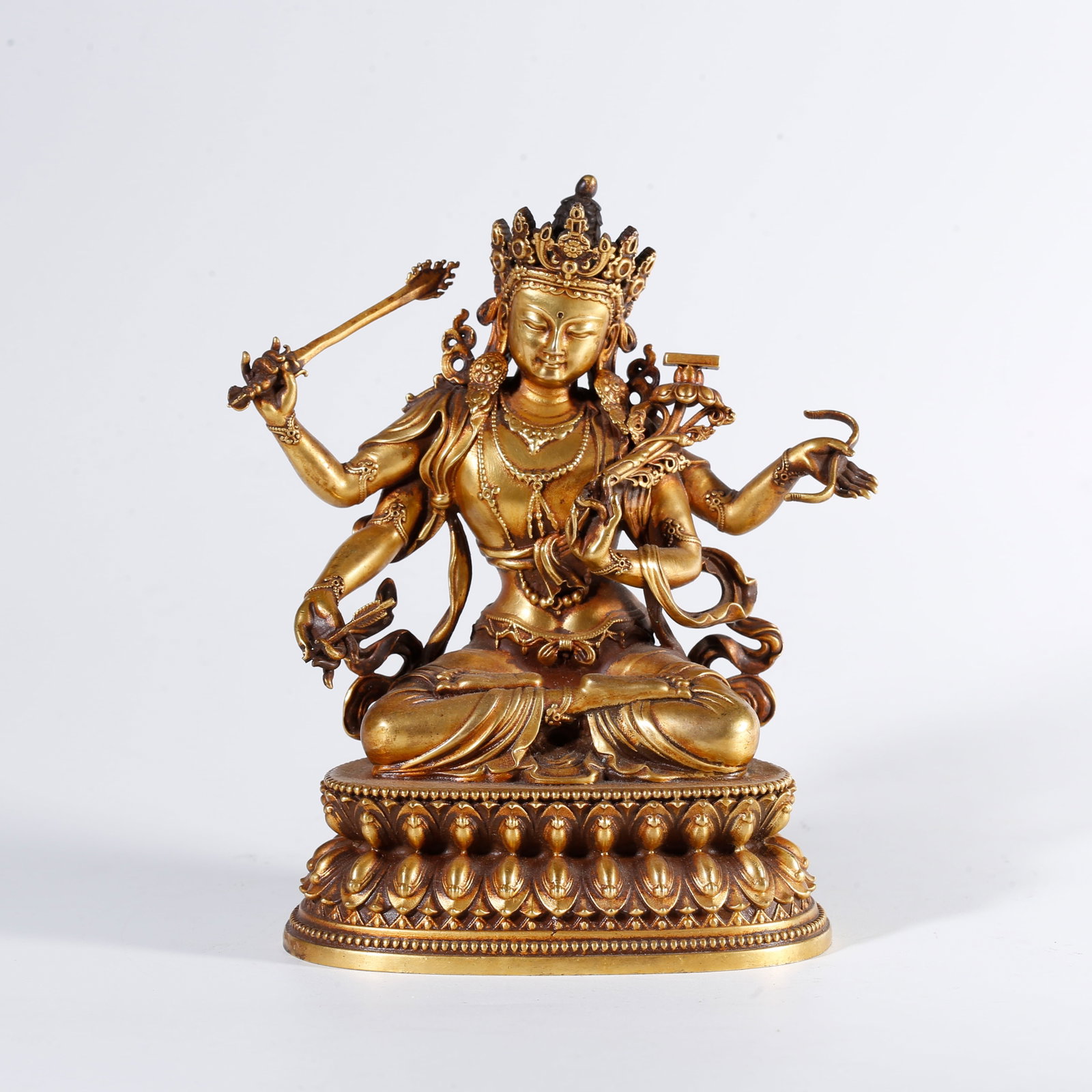 A GILT BRONZE STATUE OF FOUR-ARMED BUDDHA: Gilt Bronze Statue of Four-Armed Buddha