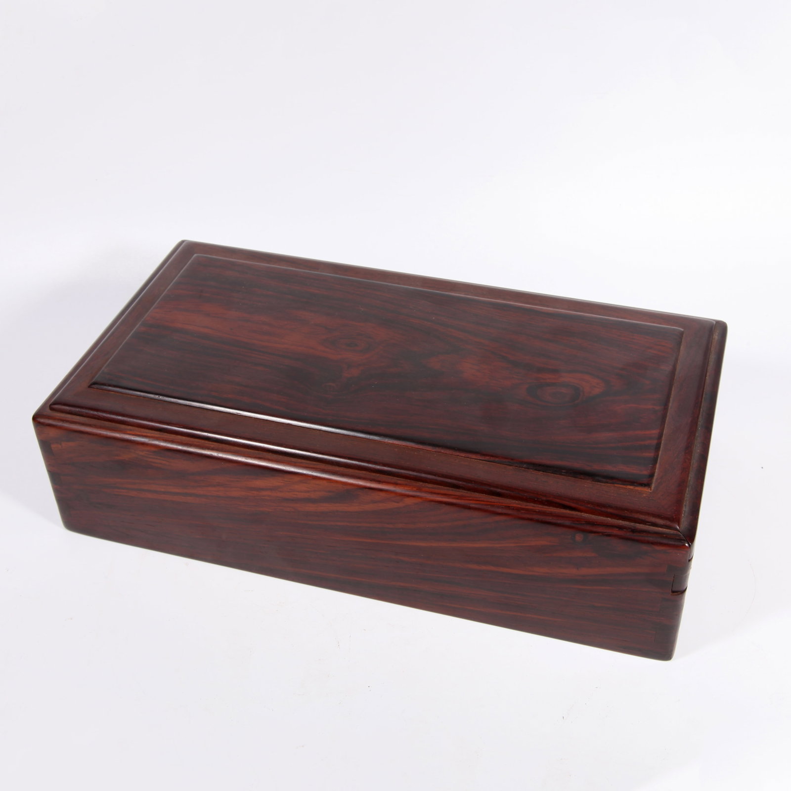 A RED WOOD COVERED BOX: Red wood covered box