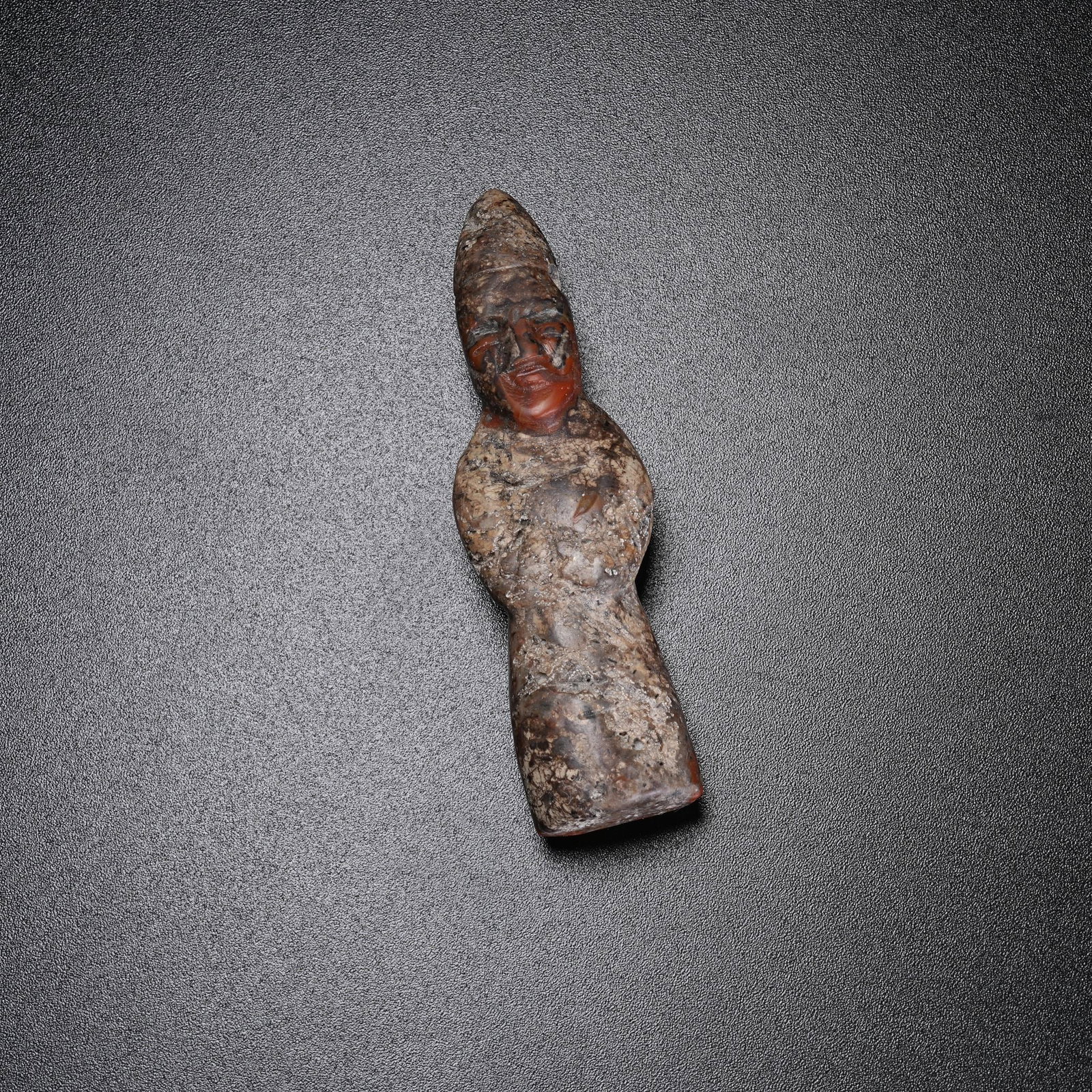 A WARRING STATES RED AGATE FIGURINE: Warring States Red Agate Figurine