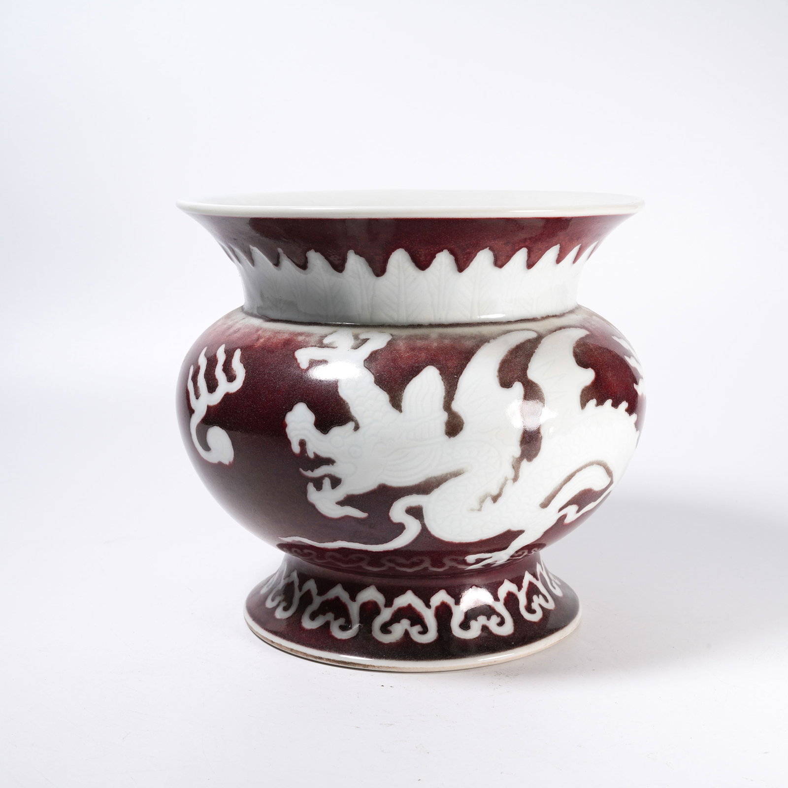 A SACRIFICIAL RED GLAZE VASE WITH RESERVED WHITE DRAGON PATTERN: Sacrificial Red Glaze Vase with Reserved White Dragon Pattern