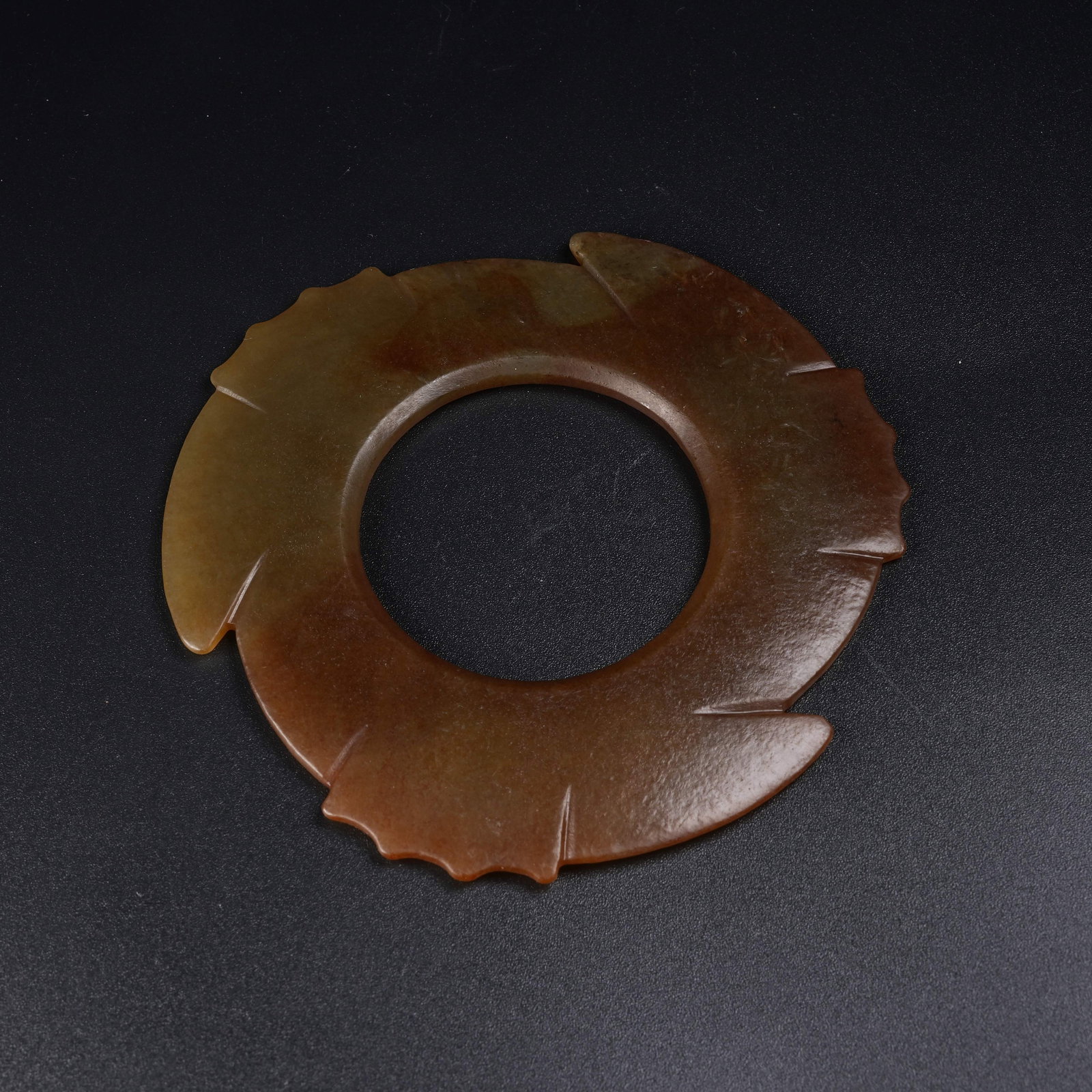 A ANCIENT JADE JADE DISC WITH SERRATED EDGE: Ancient Jade Jade Disc with Serrated Edge