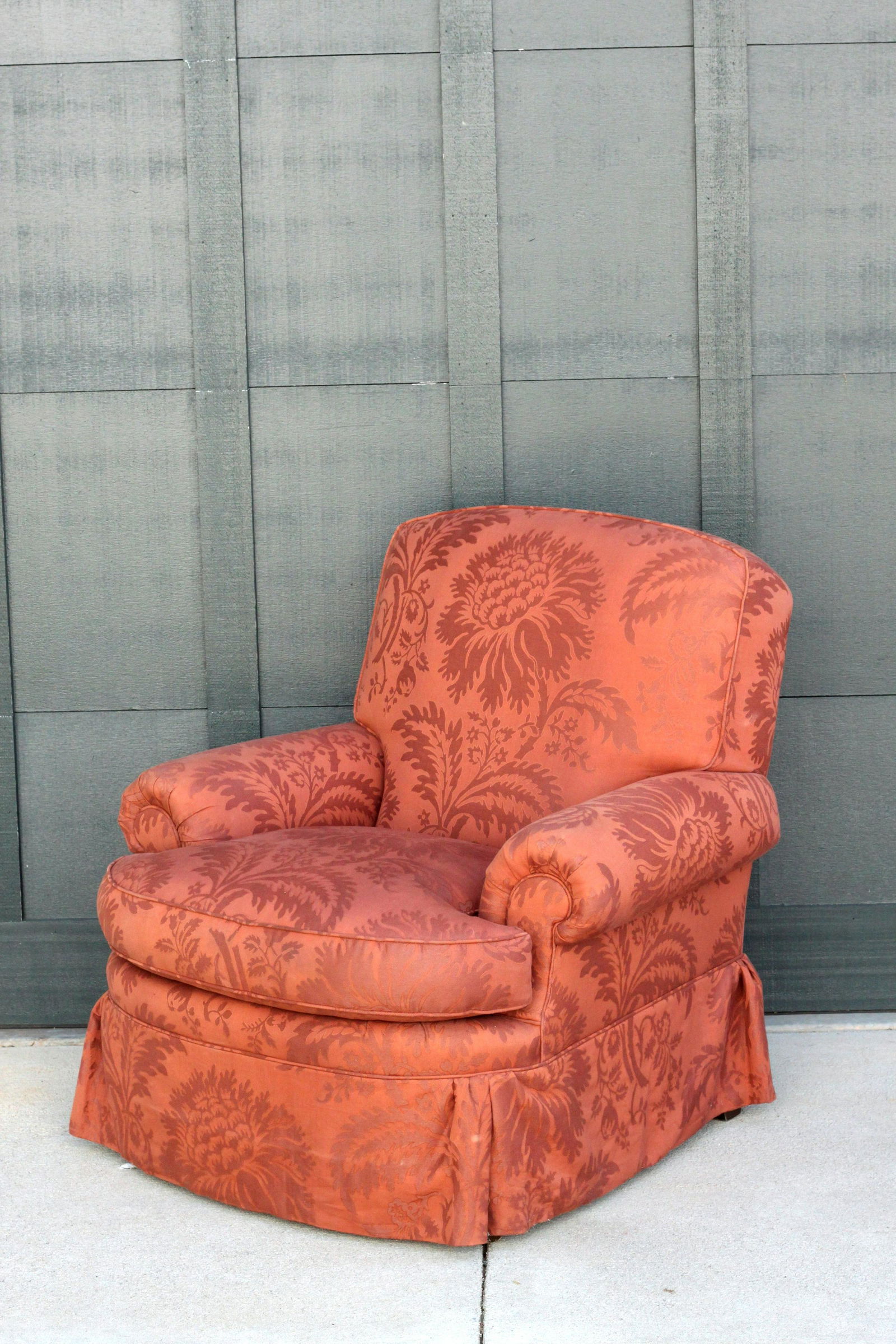 Baker Roll Arm Lounge Chair with Skirt in Rust Large Scale Damask: A nicely proportioned lounge chair by Baker in a lovely rust colored large scale damask. The chair features a tight back and down-filled loose seat cushion with a skirt that gathers gently in the corn