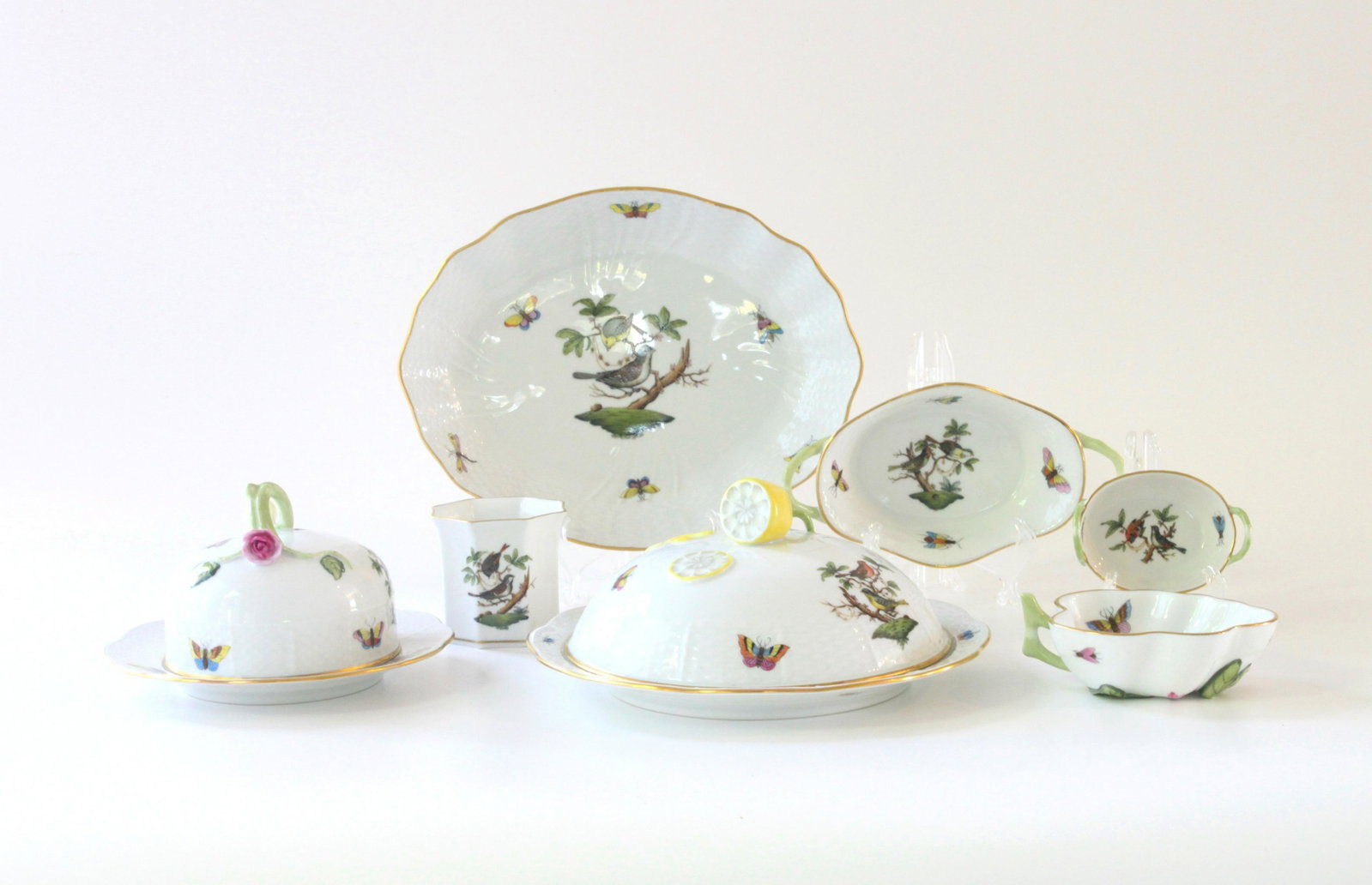 Herend Rothschild Bird Grouping with Two Cloches and Assorted Articles: A charming grouping of seven rare Rothschild Bird articles including an 8" cloche with lemon handle, 6" dia. cloche with rose stem handle, 9" W shallow dish. and four smaller articles measuring 6"W or