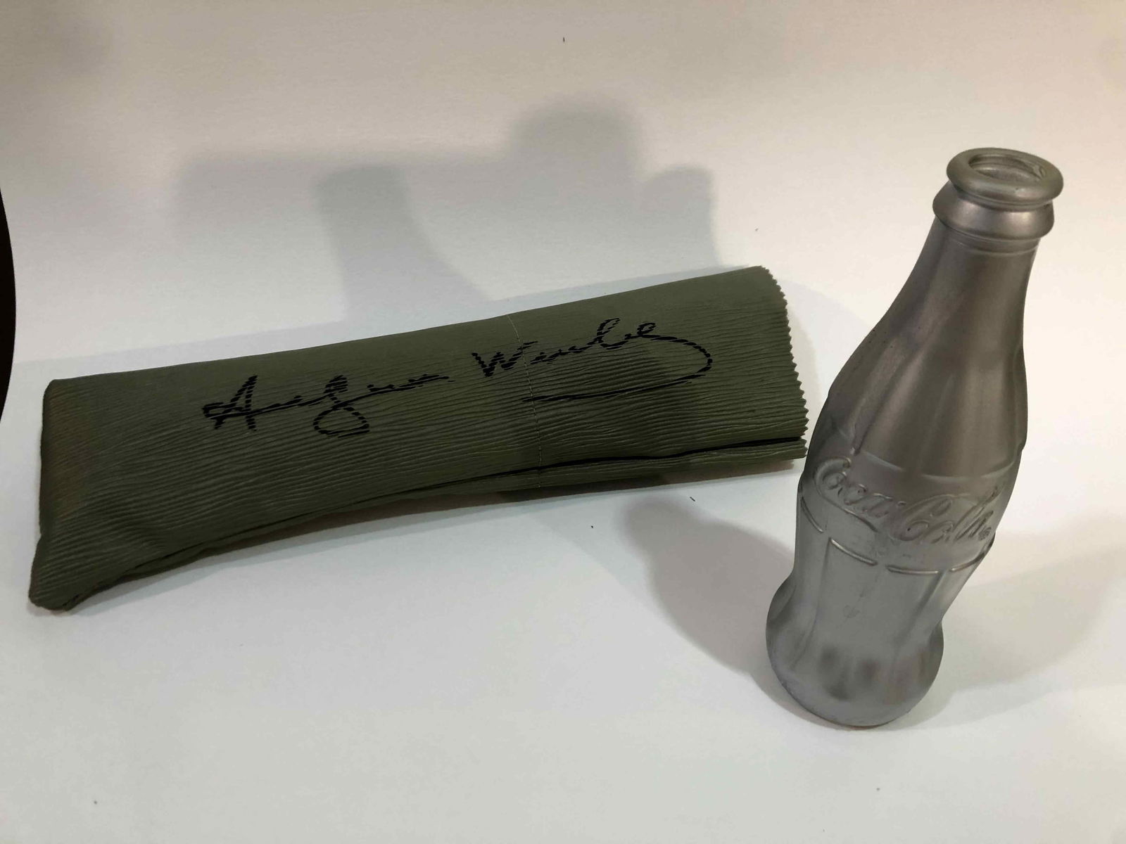 Andy Warhol Coca Cola Bottle Signed With Pencil Case And COA: Andy Warhol Coca Cola Bottle Signed With Pencil Case And COAAndy Warholcoca cola bottle originalsigned on the base AW signed in its case Andy Warhollight chip missing on the bottlesilver paintedsigned
