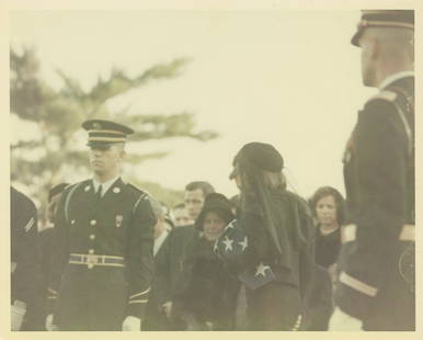 John F. Kennedy's Funeral - Jackie Holding American Flag - Original Cecil Stoughton First-Generation: Cecil Stoughton original first-generation 8 x 10" glossy photograph from John F. Kennedy's November 25, 1963 funeral. The photograph features Jackie Kennedy along with fellow family members and