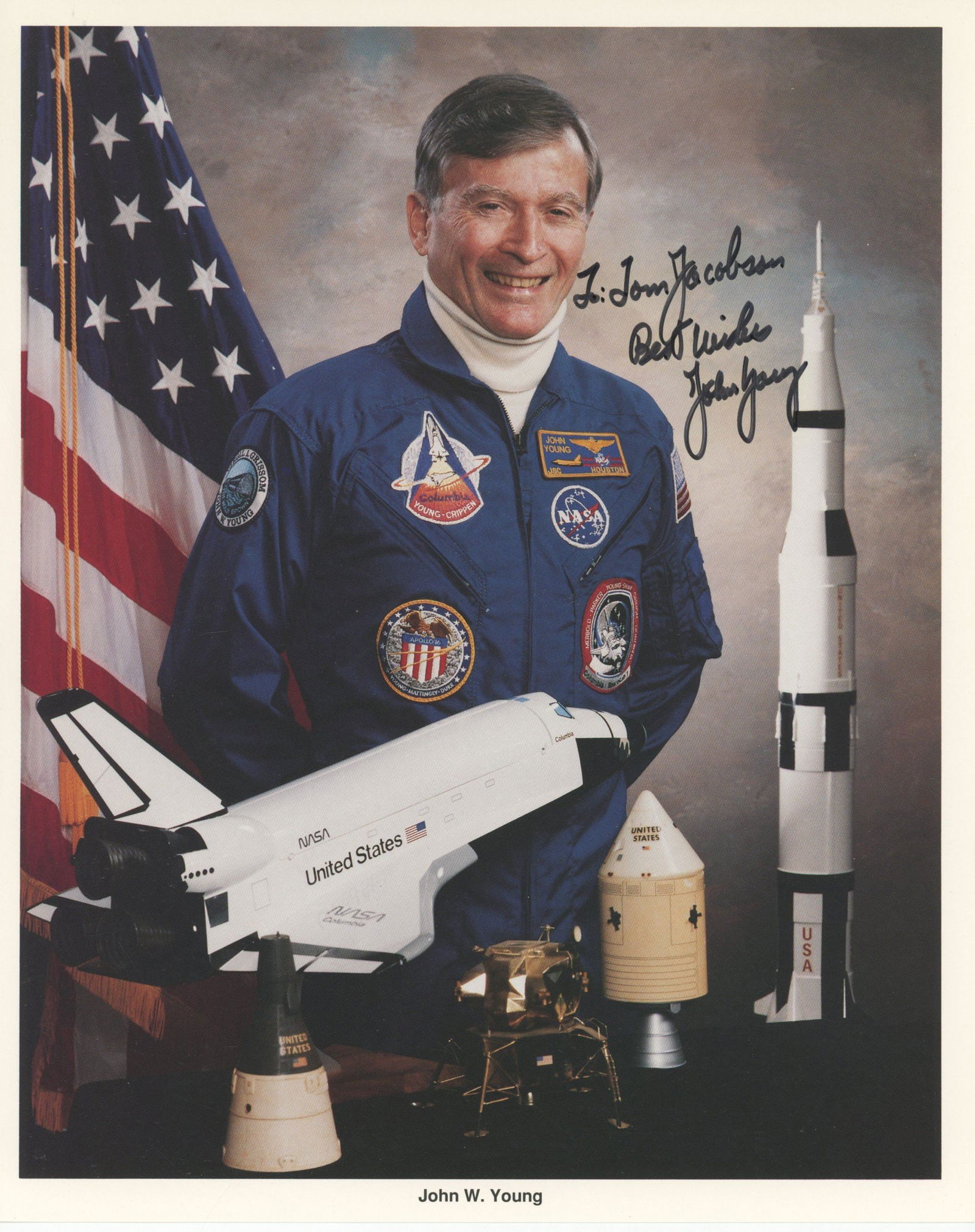 John Young – Gemini, Apollo & Space Shuttle Astronaut – Autographed 8 x 10" Official NAS: Details: Official NASA 8 x 10" color lithograph portrait of John W. Young, boldly inscribed and signed in black ink. Pictured in his blue NASA flight suit, Young poses beside scale models of the Apoll