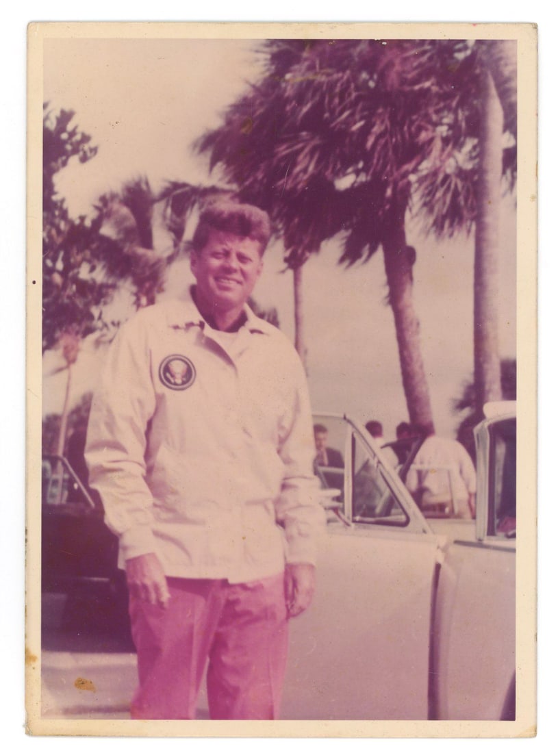 John F. Kennedy – Palm Beach, Florida – Original Period 5 x 7" Color Photograph (1962): Details: John F. Kennedy original 5 x 7” period color photograph taken in Palm Beach, Florida, in December 1962. The image depicts Kennedy standing outdoors among palm trees, dressed casually