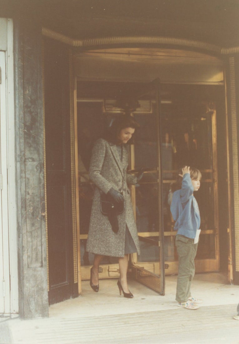 Jacqueline & John Kennedy Jr. – Original 5 x 7” Candid Photo – Peter Warrack Archi: Details: Jacqueline Kennedy and John F. Kennedy Jr. captured in an original period 5 x 7” candid photograph, depicting the former First Lady exiting a building alongside her young son in a