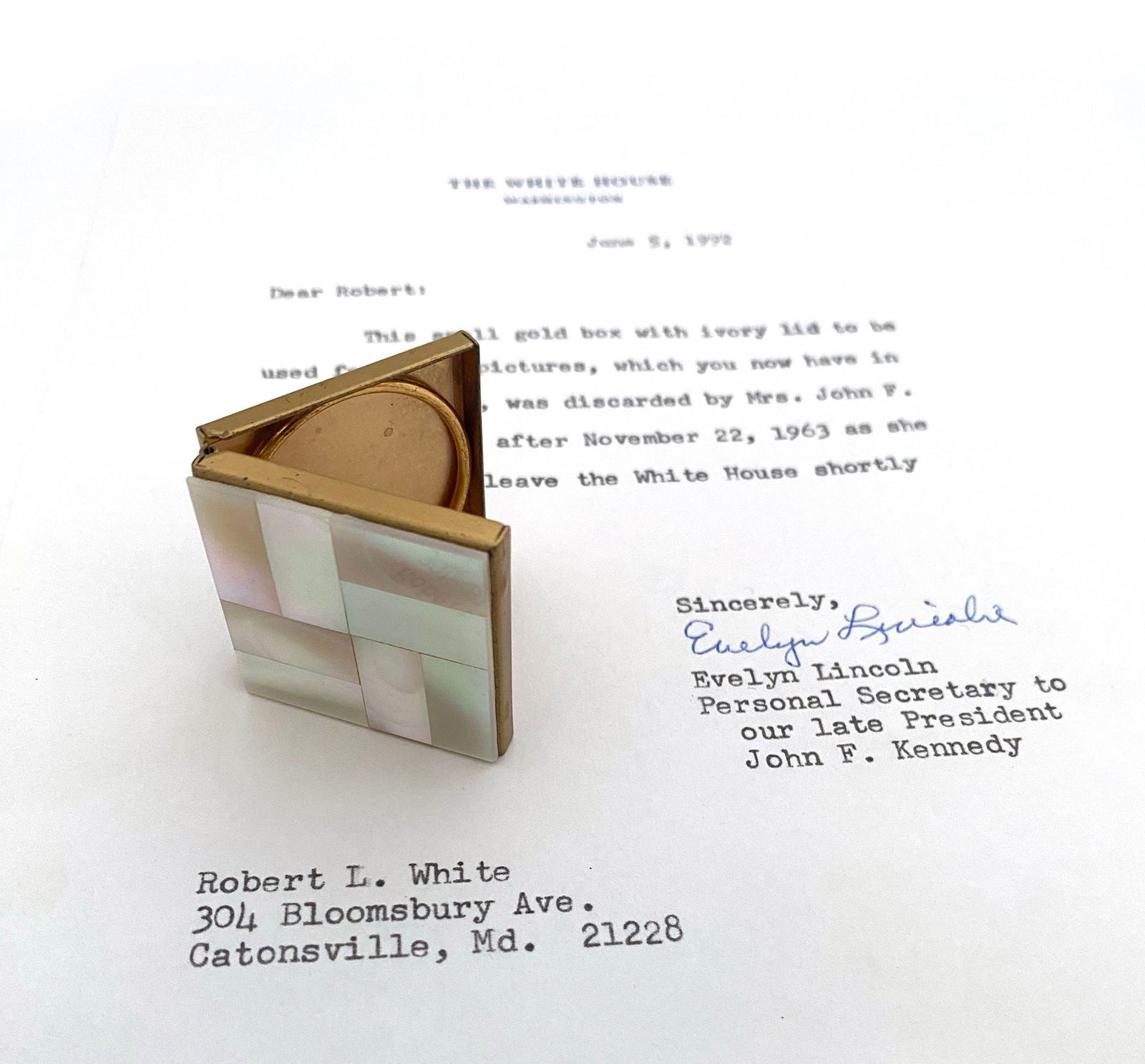 Jacqueline Kennedy – Personally Owned Ivory Lid Gold Photo Box with Evelyn Lincoln Provenance: Details: Jacqueline Kennedy personally owned 1.25 × 1.25 inch gold-toned photograph box with an ivory lid, retained from her time in the White House and accompanied by a typed letter of