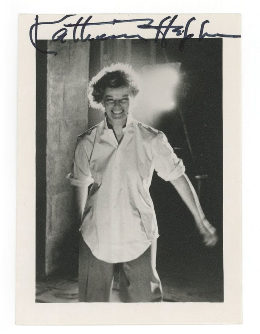 Katharine Hepburn – Academy Award-Winning Actress – Autographed 3.5 x 5" Photo: Details: Katharine Hepburn 3.5 x 5" black-and-white photograph. The image features Hepburn in a posed shot, captured mid-stride with dramatic backlighting that highlights her unmistakable presence