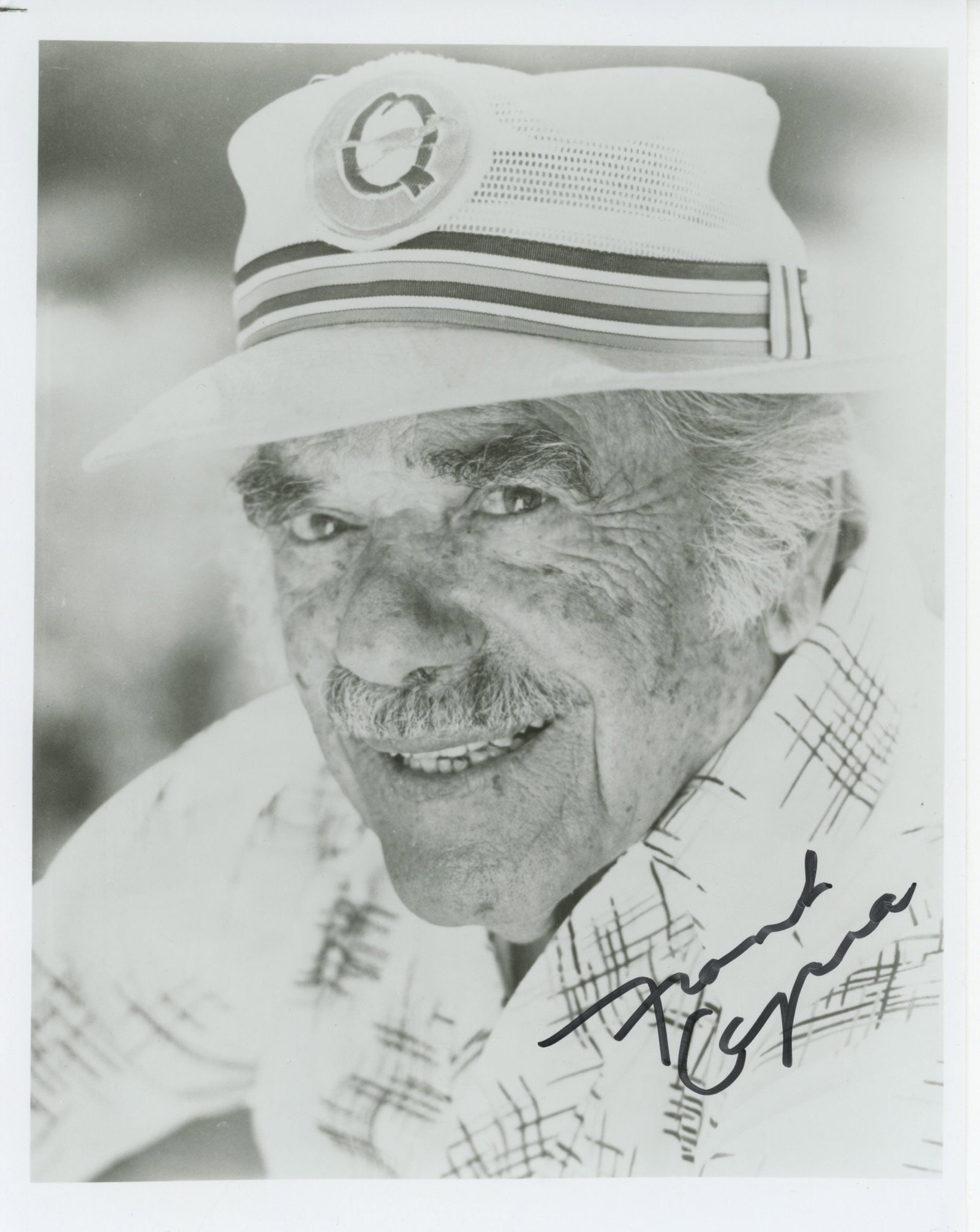 Frank Capra – Academy Award-Winning Film Director – Autographed 8 x 10" Photograph: Details: Frank Capra 8 x 10" black-and-white photograph showing the legendary director in a close-up portrait, wearing a light hat and patterned shirt. Autographed in black marker along the lower