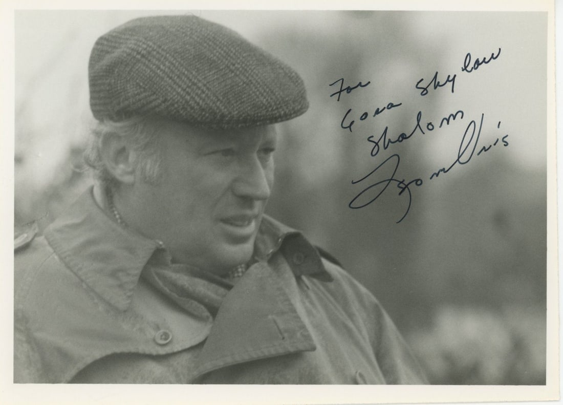 Leon Uris – Author of Exodus – Autographed 7 x 5" Photograph: Details: Leon Uris 7 x 5" black-and-white photograph showing the author in a candid outdoor portrait, wearing a flat cap and coat. Inscribed in black ink at upper right, “For Gona Shylaw,