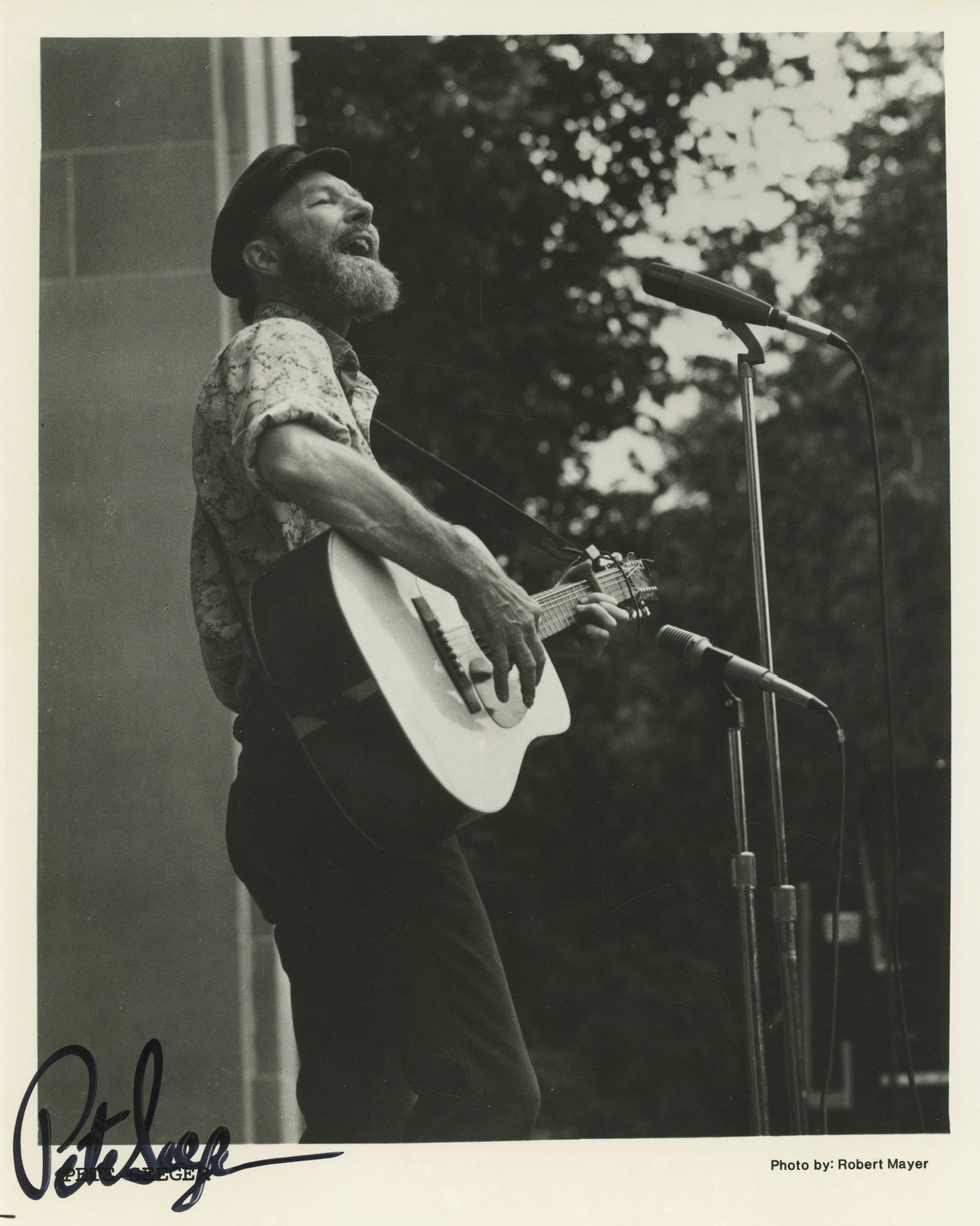 Pete Seeger – Folk Music Legend – Autographed 8 x 10 Photo: Details: Pete Seeger autographed 8 x 10” glossy black and white photograph depicting the influential folk singer performing with guitar before a microphone. The photograph is signed in bold