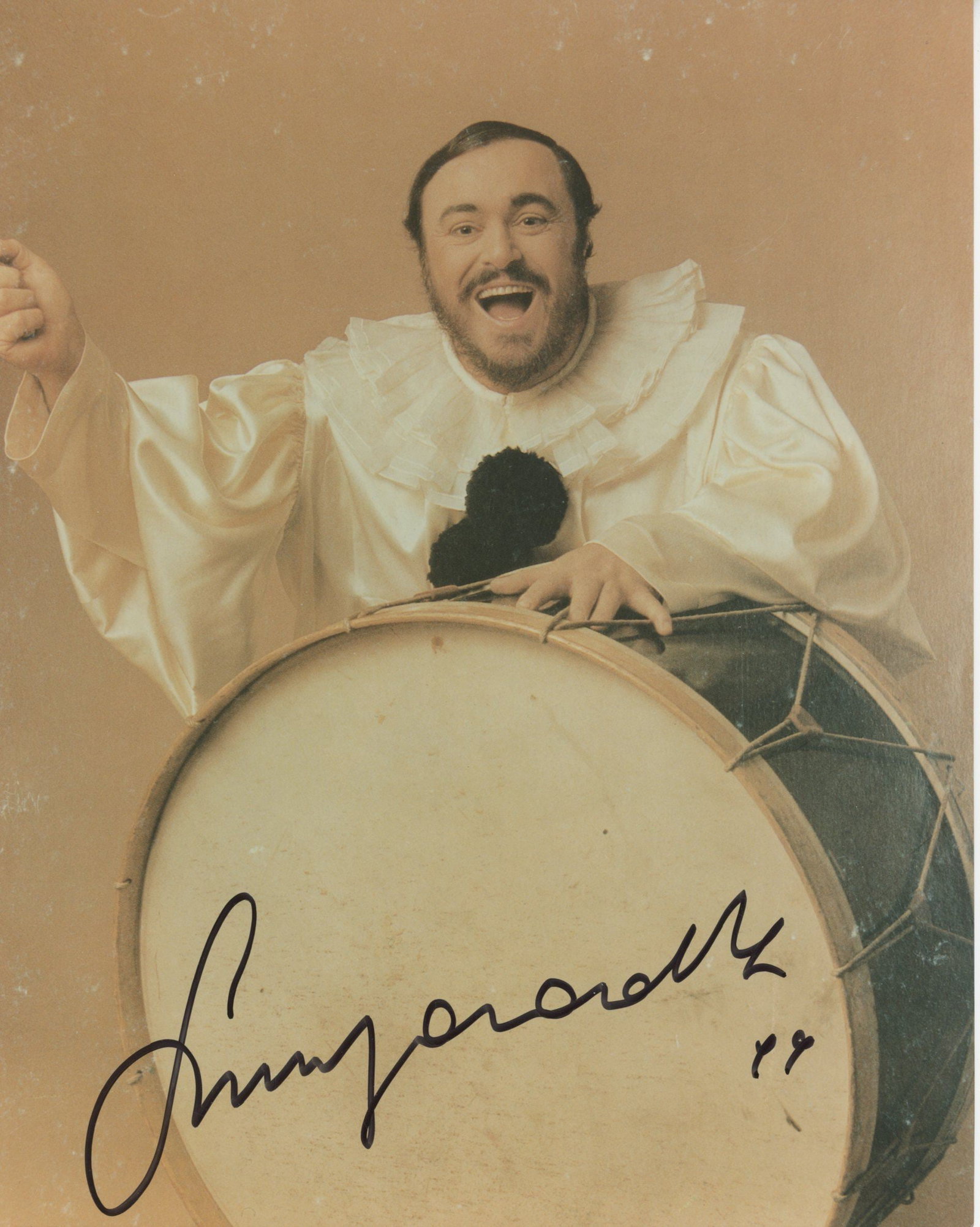 Luciano Pavarotti – Operatic Tenor – Autographed 8 x 10” Photograph: Details: Luciano Pavarotti color 8 x 10” stage photograph showing the legendary tenor in theatrical costume, autographed in dark ink across the drumhead. Fine condition.Luciano Pavarotti