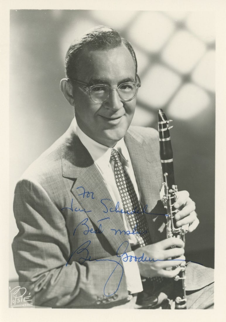 Benny Goodman – “King of Swing” Jazz Icon – Autographed 5 x 7" Photograph: Details: Benny Goodman 5 x 7" black-and-white photograph showing the legendary clarinetist in a studio portrait, seated in suit and tie while holding his clarinet. Inscribed in blue ink, “For
