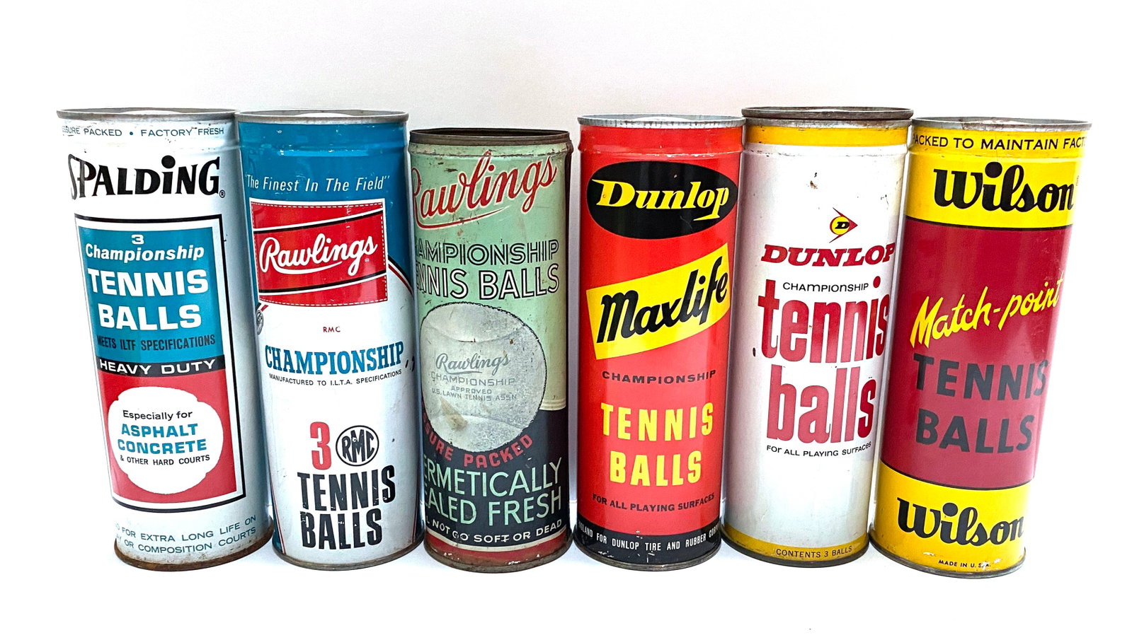 Vintage Tennis Ball Can Collection - Six Mid-Century Advertising Cans: Details: Collection of six vintage tennis ball cans from various manufacturers, including Spalding Championship Heavy Duty, Rawlings Championship, Rawlings Championship Hermetically Sealed Fresh,
