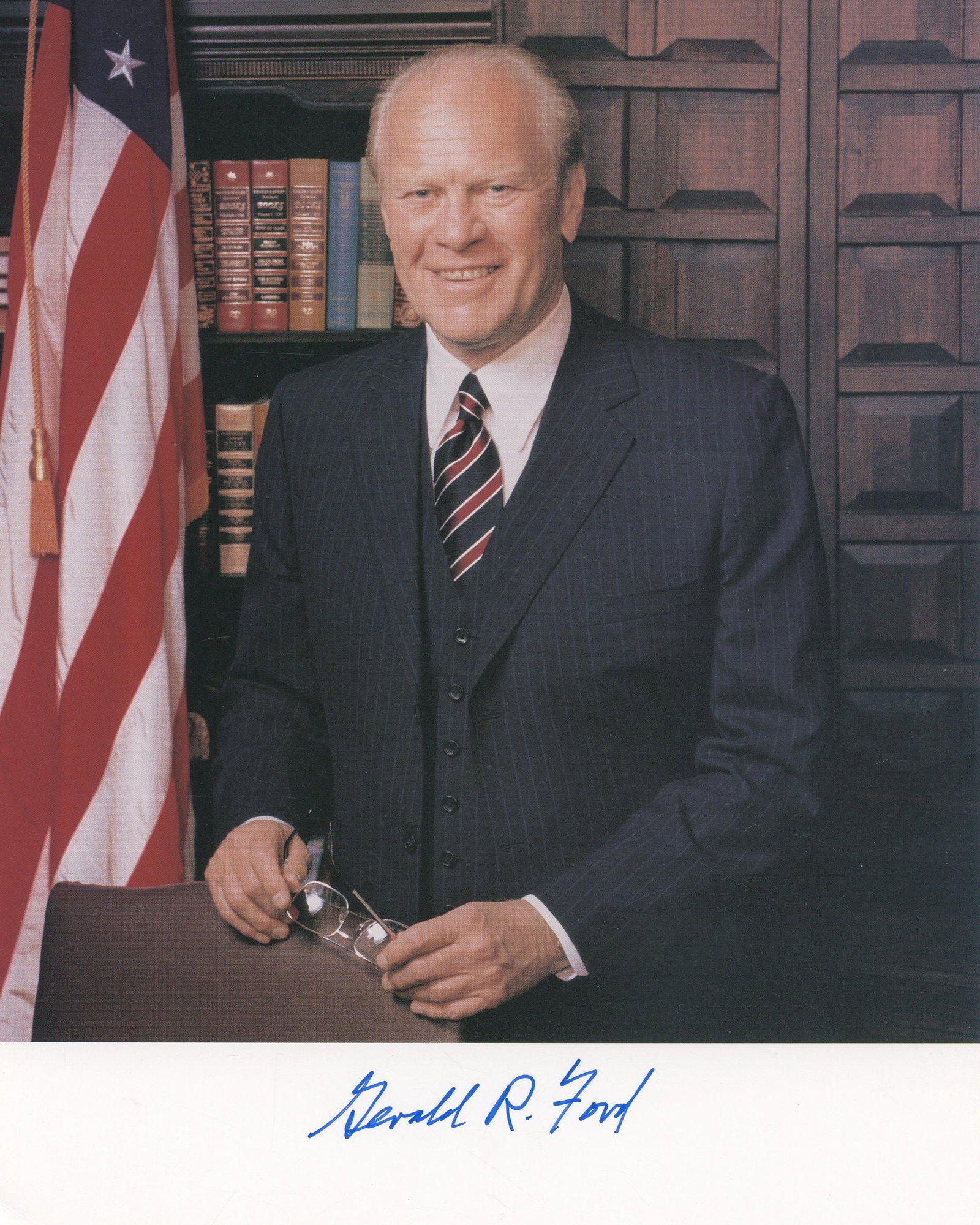 Gerald R. Ford - 38th President of the United States - Autographed 8 x 10 Photograph: Details: Gerald R. Ford autographed 8 x 10 matte finish color portrait photograph depicting the 38th President of the United States standing in his White House office before an American flag and