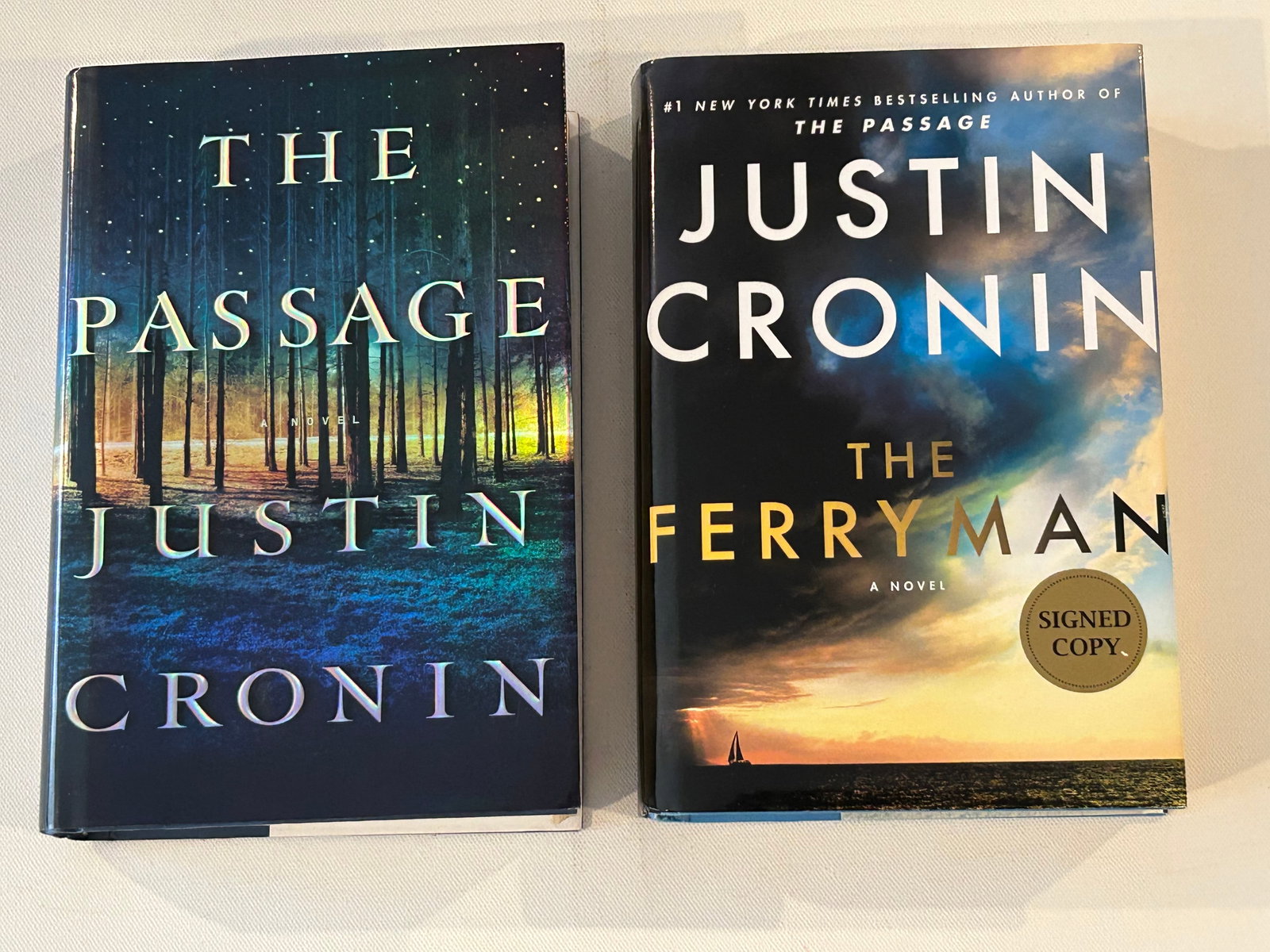 Justin Cronin SIGNED First Editions: The Passage SIGNED First Edition published by Ballantine Books, New York, 2010. The Ferryman SIGNED First Edition published by Ballantine Books, New York, 2023. Dimensions: 11" x 9" x 6"