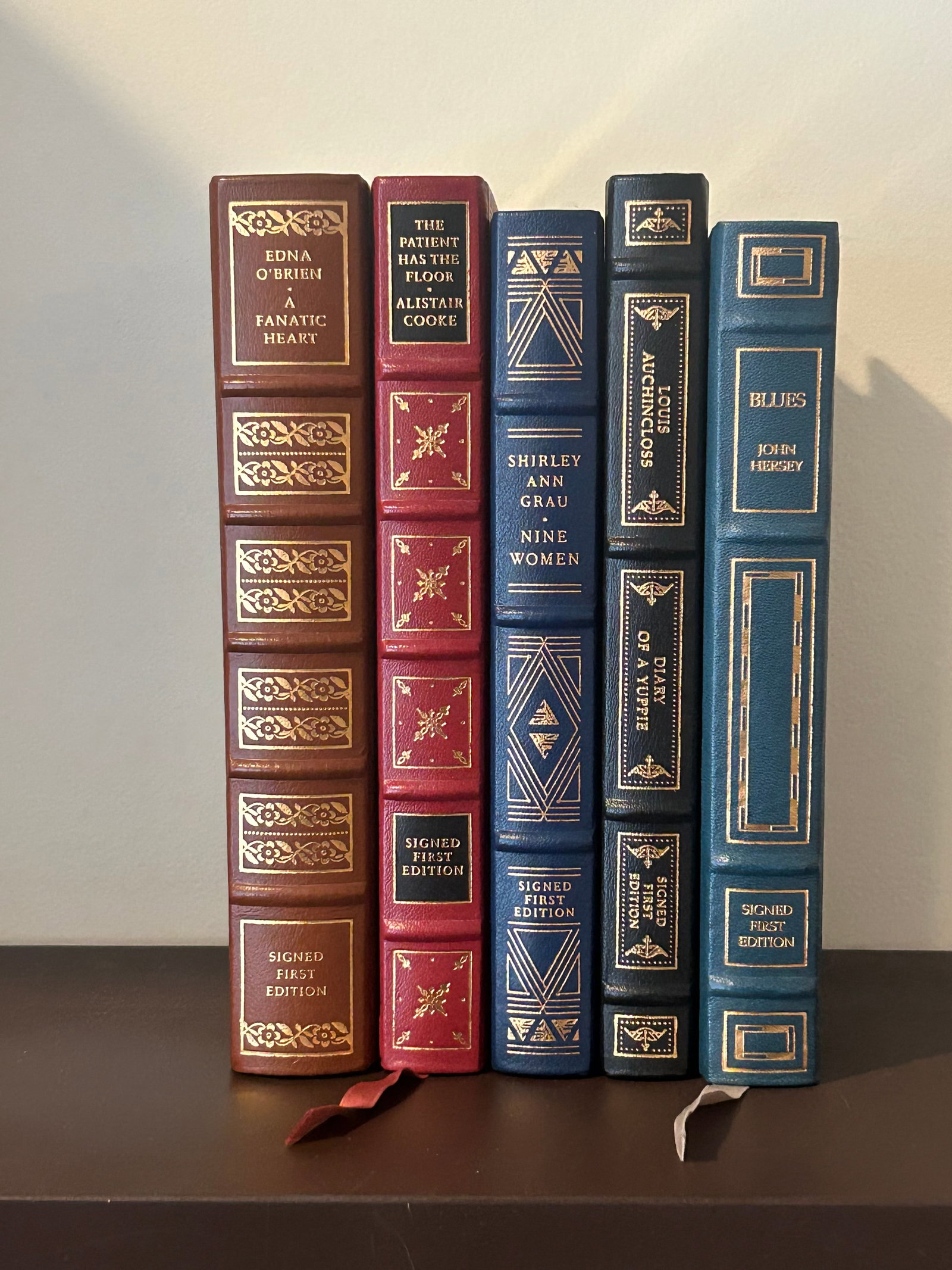 Franklin Library SIGNED First Edition Leather Bound Books: Blues by John Hersey, Diary Of A Yuppie by Louis Auchincloss, Nine Women by Shirley Ann Grau, The Patient Has The Floor by Alistair Cooke, Fanatic Heart by Edna O'Brien. Dimensions: 11" x 9" x 12