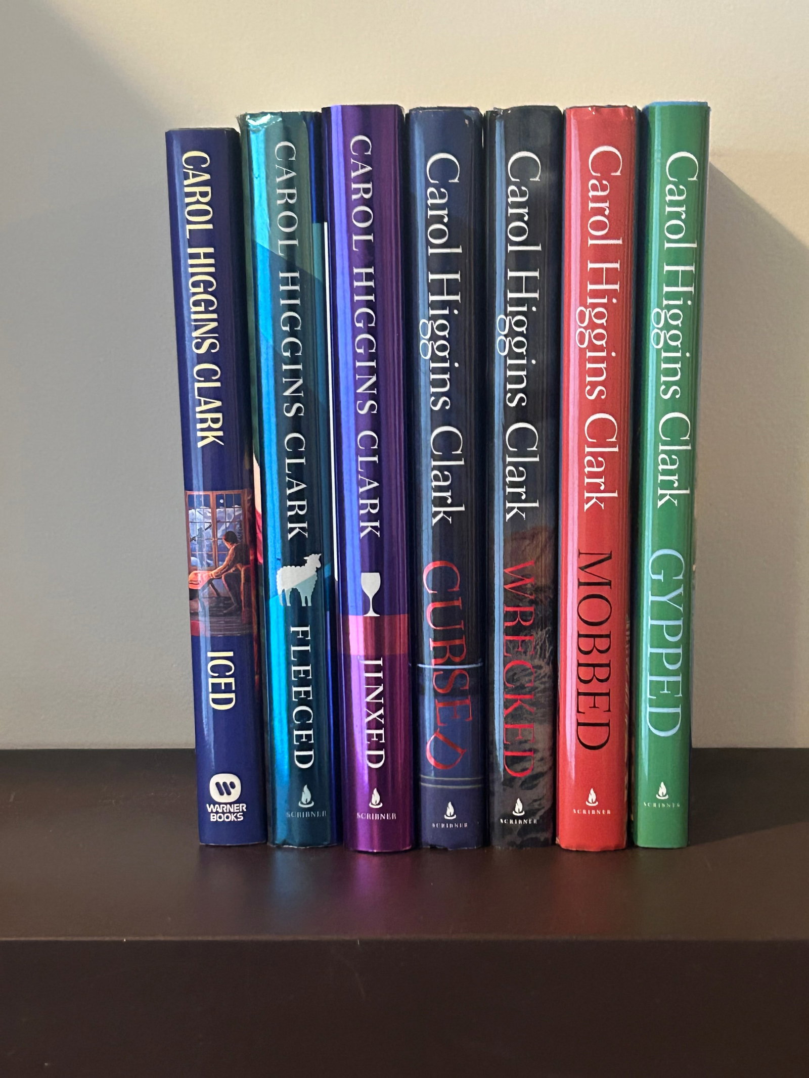 Carol Higgins Clark SIGNED Editions: Iced, Fleeced, Jinxed, Cursed, Wrecked, Mobbed & Gypped SIGNED/Inscribed Editions published by Warner Books & Scribner, New York. Dimensions: 11" x 9" x 12"