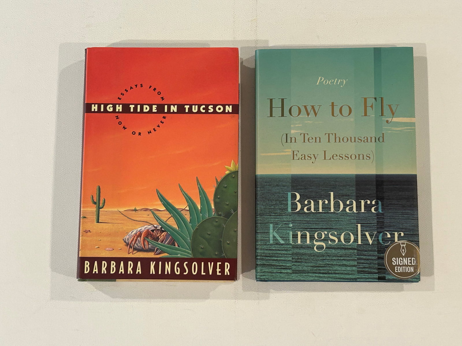 High Tide In Tucson & How To Fly by Barbara Kingsolver SIGNED First Editions: High Tide In Tucson & How To Fly by Barbara Kingsolver SIGNED First Editions published by Harper Collins, New York, 1995, 2020. Dimensions: 11" x 9" x 4"