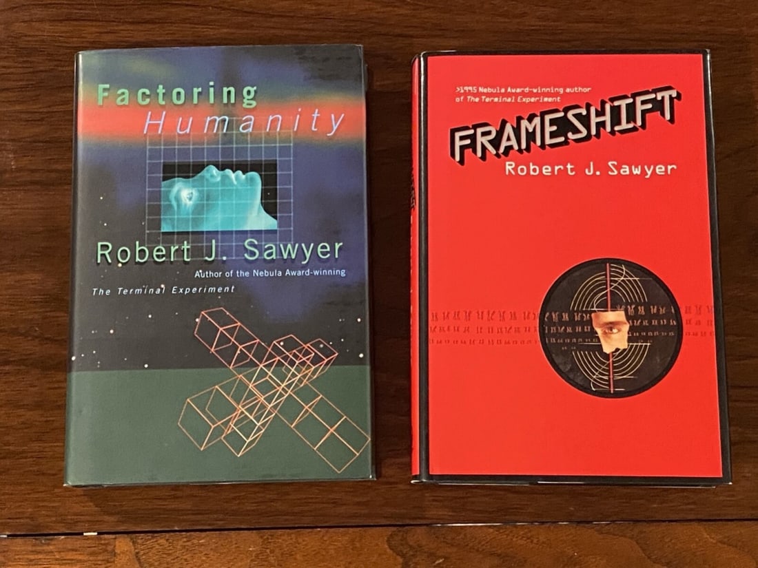 Factoring Humanity & Frameshift By Robert J. Sawyer SIGNED & Inscribed Editions: Factoring Humanity SIGNED & Inscribed First Edition published by TOR, New York, 1998. Frameshift SIGNED & Inscribed First Edition, Second Printing published by TOR, New York, 1997. Dimensions: 11" x 9