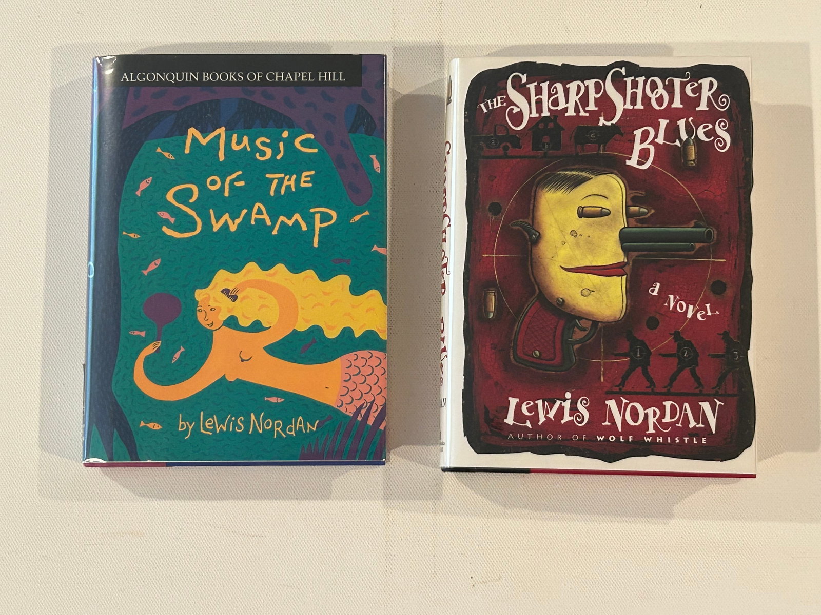 Lewis Nordan SIGNED First Editions: Music Of The Swamp & The Sharpshooter Blues by Lewis Nordan SIGNED First Editions published by Algonquin Books Of Chapel Hill, 1991, 1995. Dimensions: 11" x 9" x 2"